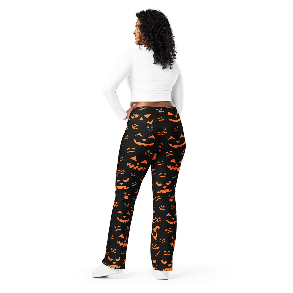 Women’s black high waist flare leggings with vibrant orange jack-o-lantern face pattern for Halloween