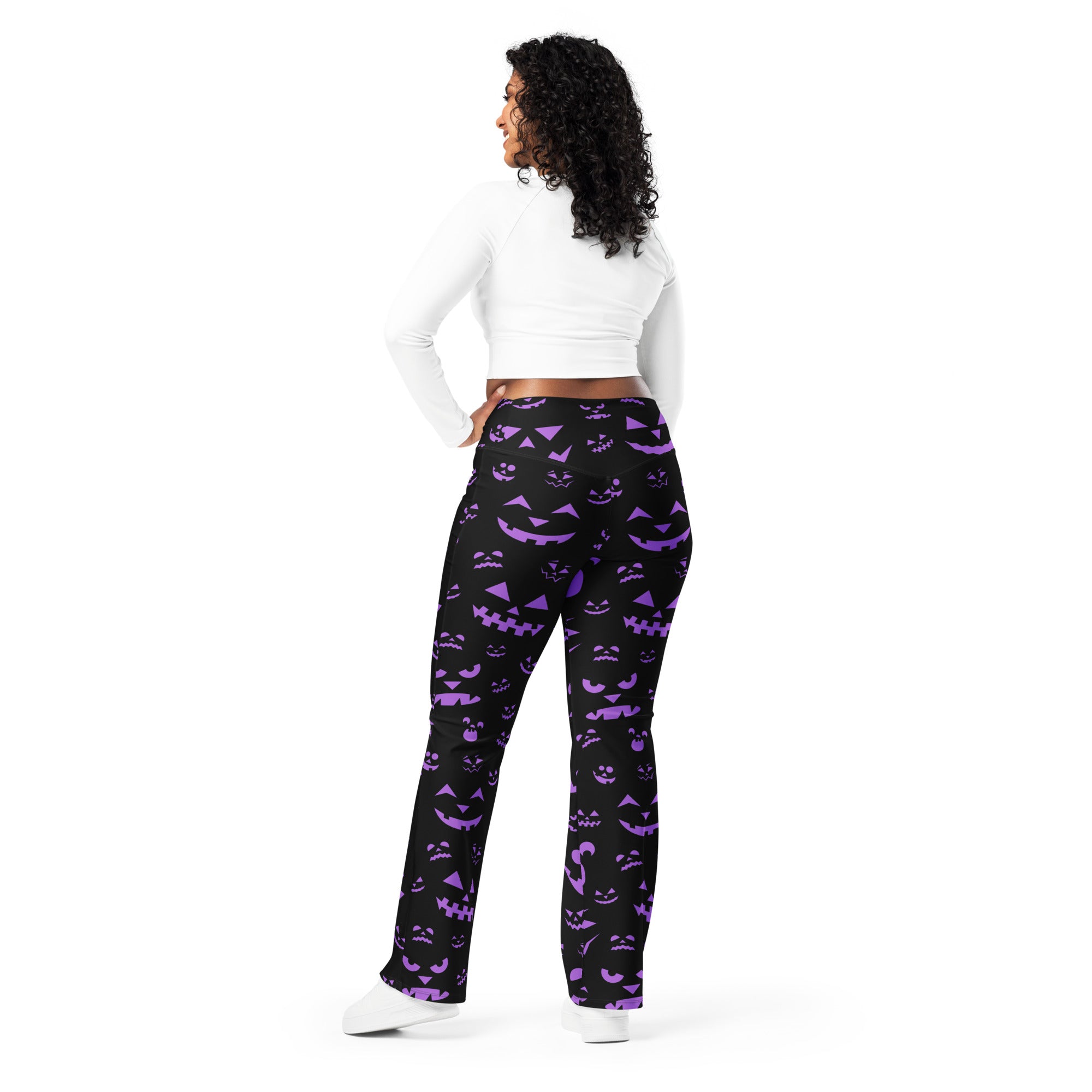 Women’s black high waist flare leggings with vibrant purple jack o lantern halloween pattern