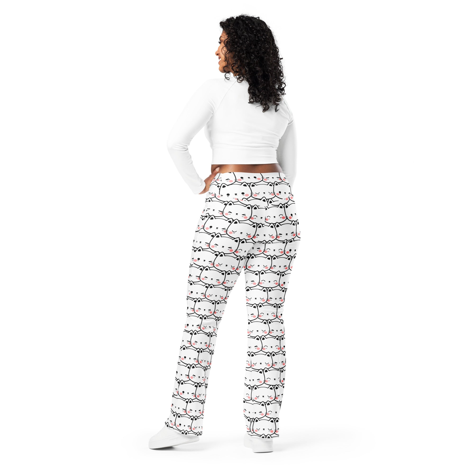 Women’s white high waist flare legging pants with playful black outlined cartoon cats and pink accents pattern