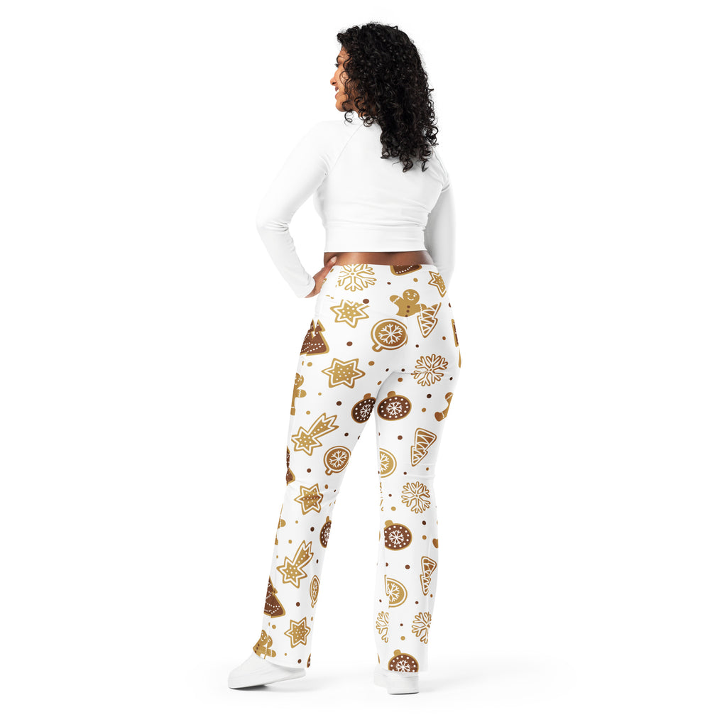 White women’s high waist flare legging pants with festive gold gingerbread cookies stars and ornaments pattern