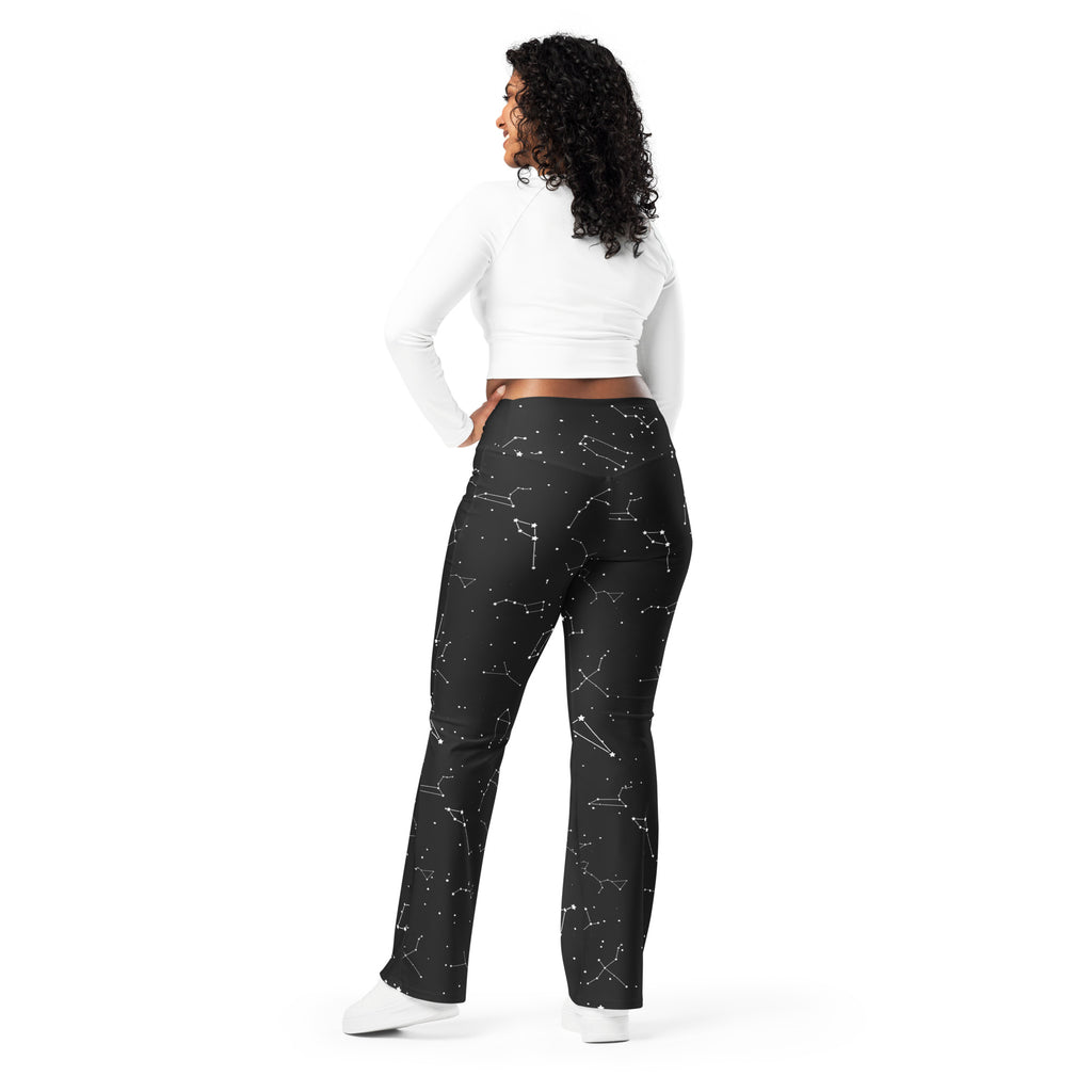 Women’s black high waist flare leggings with white realistic constellation outlines and scattered star patterns