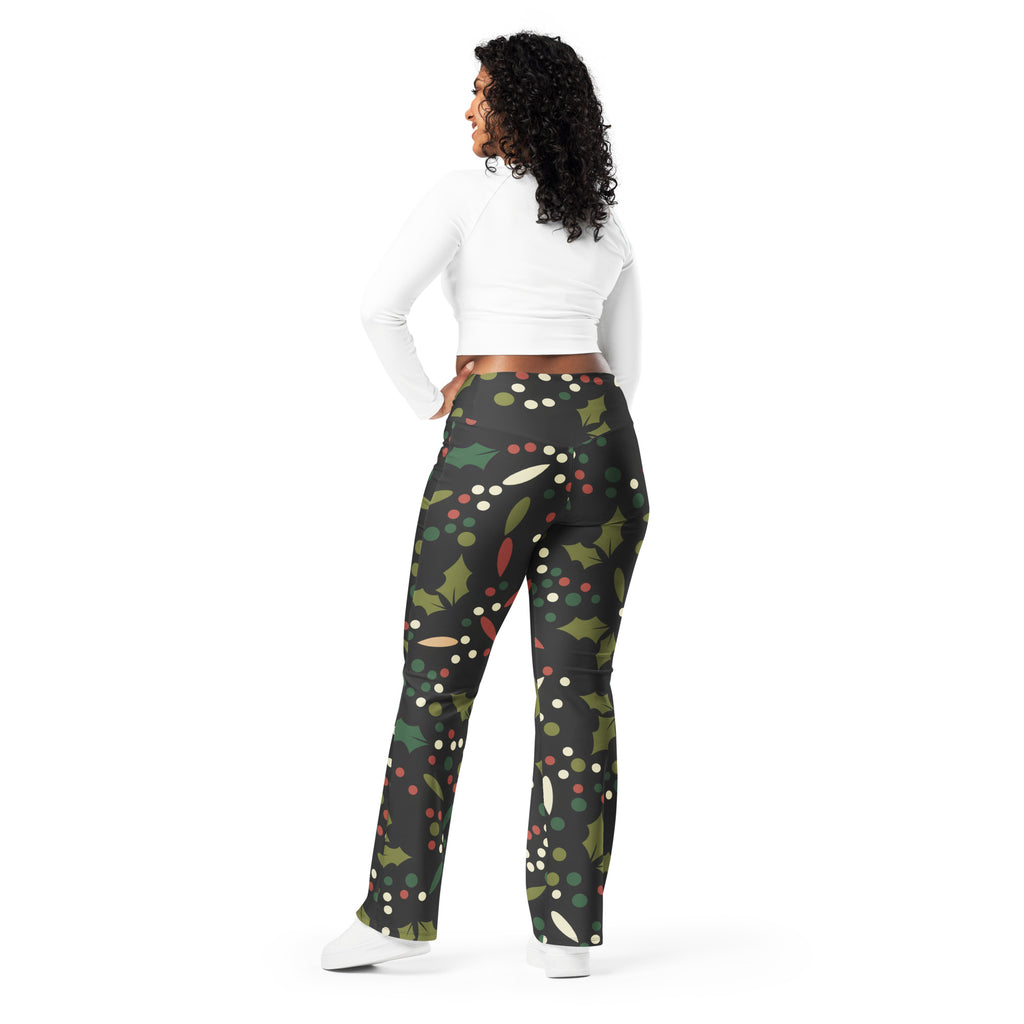 Black leggings with a festive green holly leaf red berry and white dot pattern high waist flare style for women