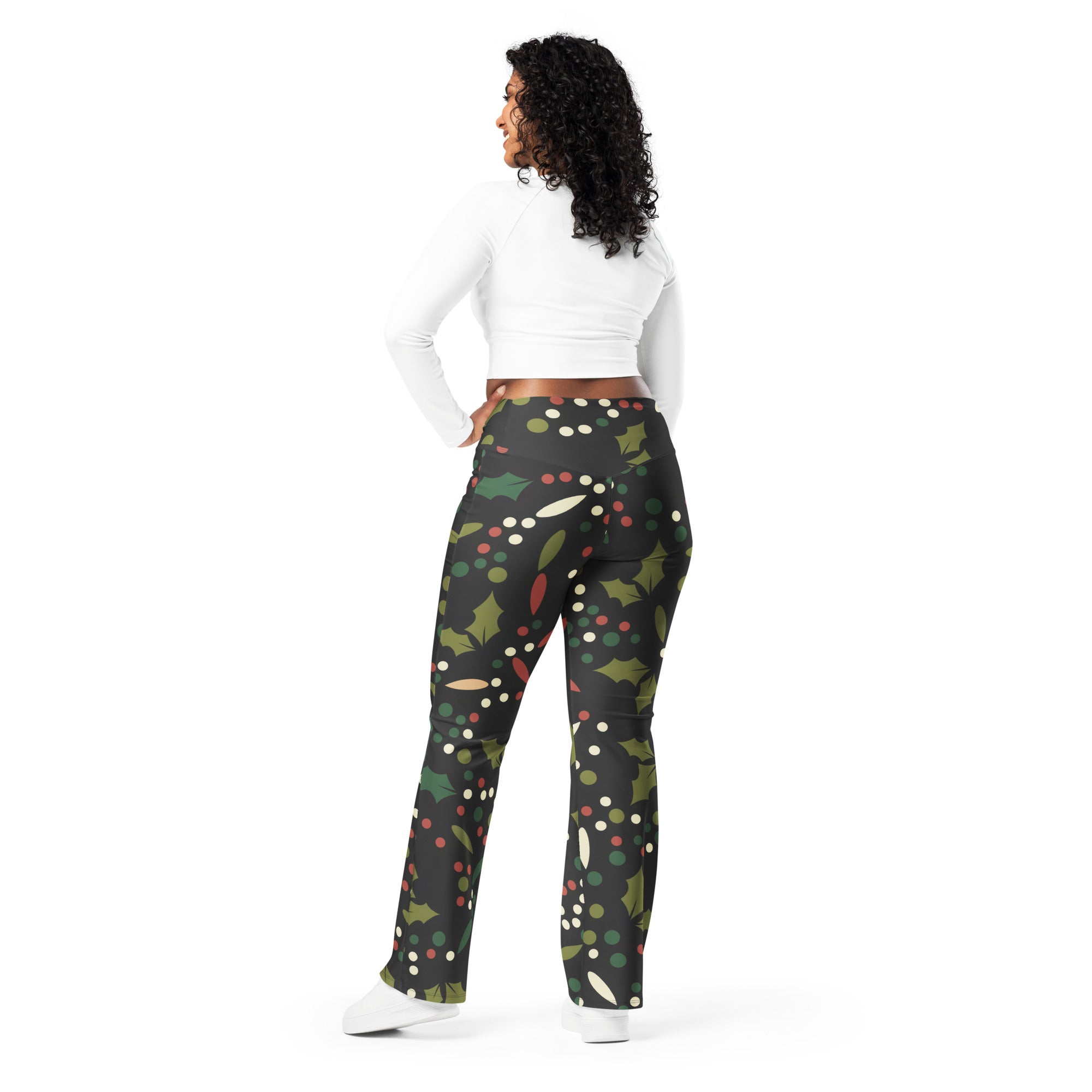 Black leggings with a festive green holly leaf red berry and white dot pattern high waist flare style for women