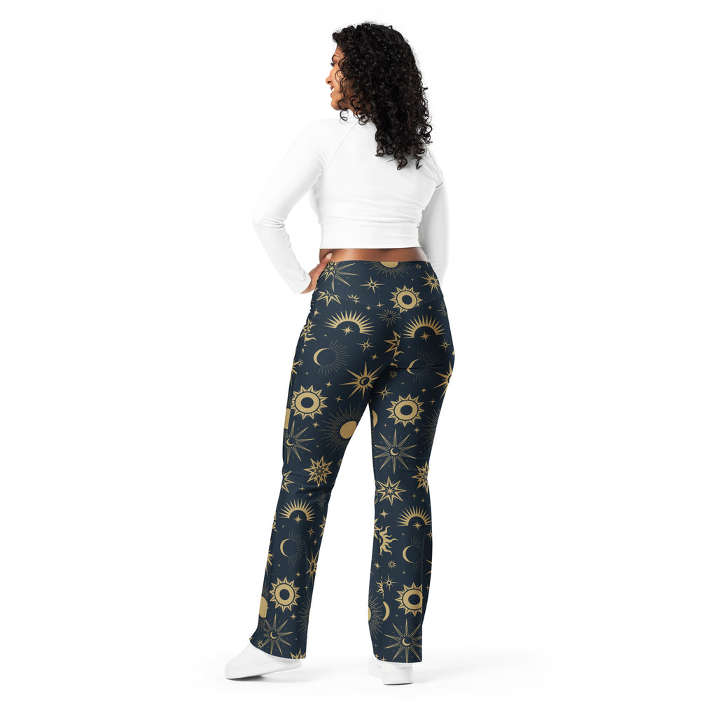 Women’s dark blue high-waisted flare legging pants with vibrant gold celestial sun moon and star pattern