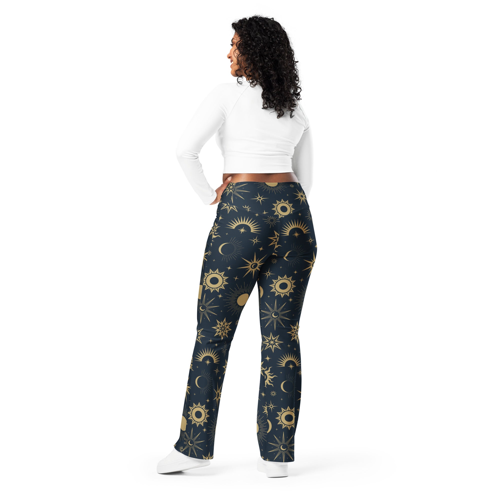 Women’s dark blue high-waisted flare legging pants with vibrant gold celestial sun moon and star pattern