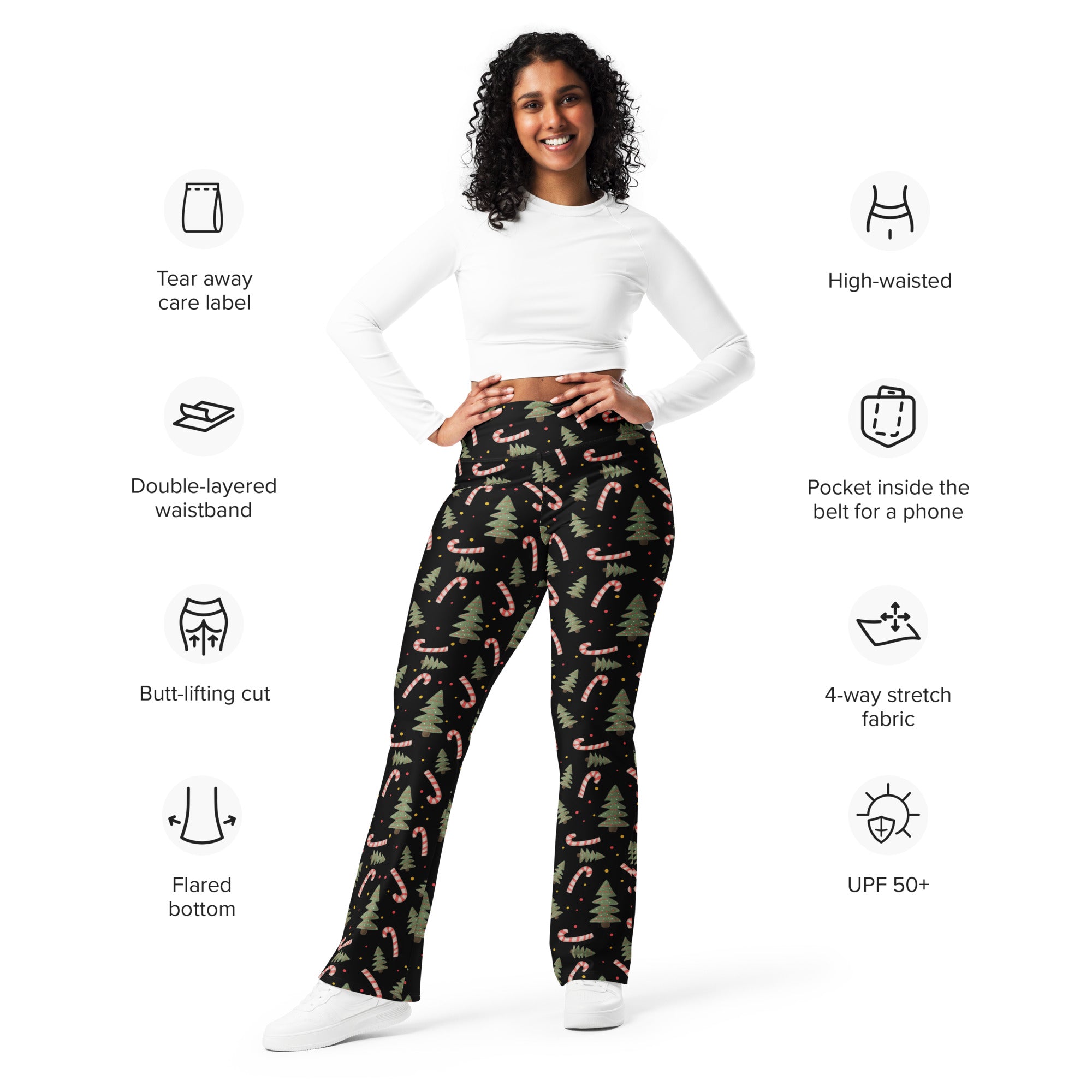 Women’s black high-waisted flare legging pants with festive pink candy cane and green pine tree pattern