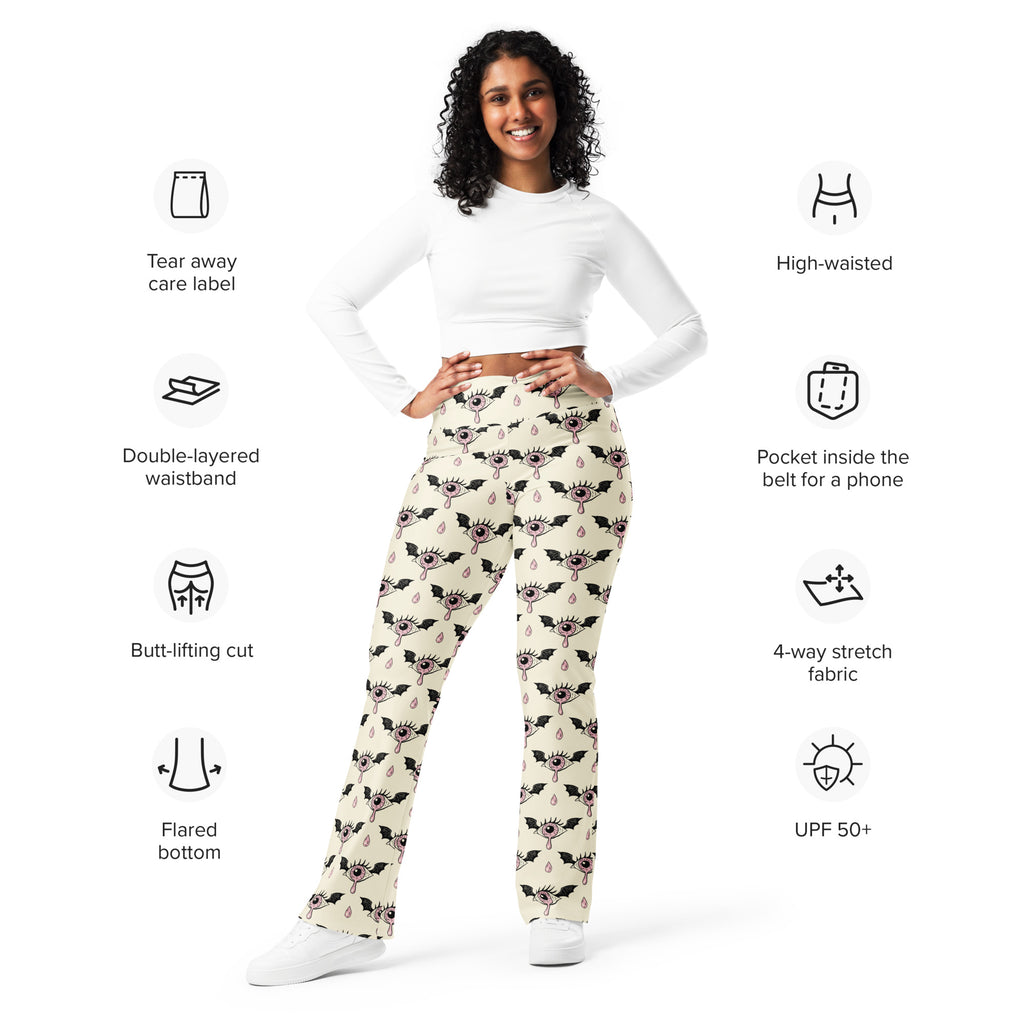 Cream-colored women’s high waist flare legging pants with black eyeball and bat gothic pattern
