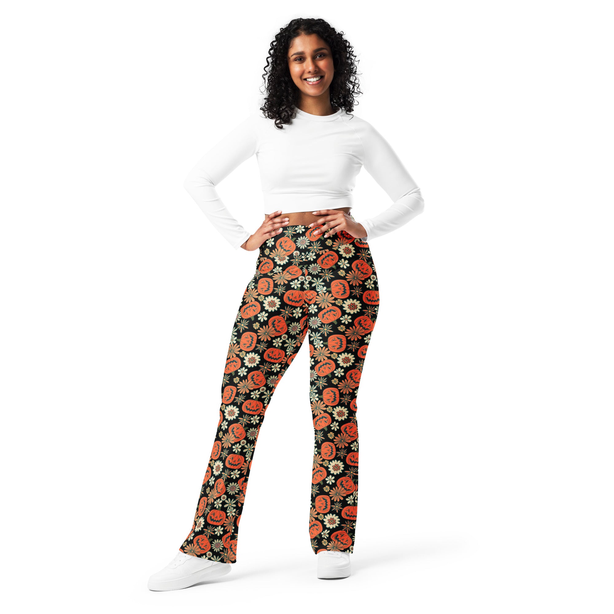 Women’s retro halloween high waist flare legging pants in black with orange jack o lantern and white daisy pattern