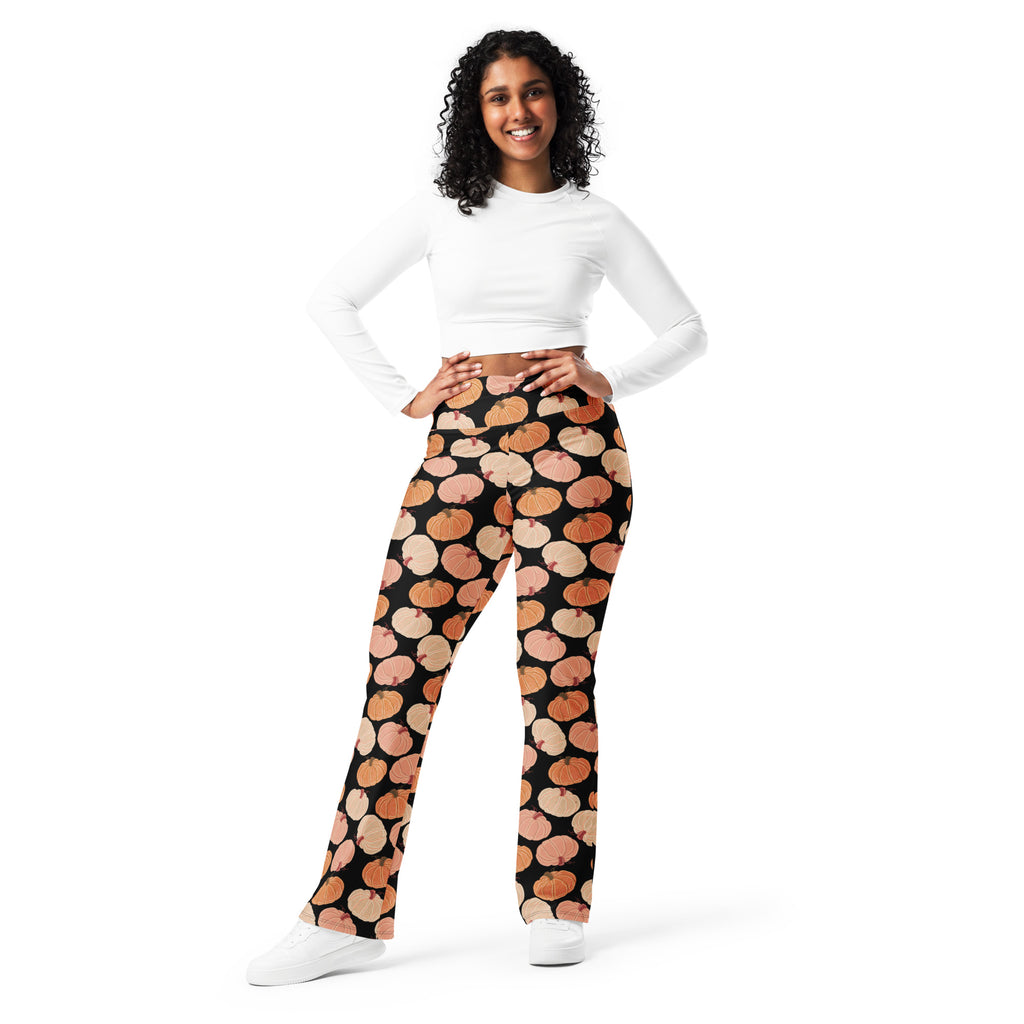 Women’s black high waist flare leggings with repeating orange and beige stylized pumpkin pattern