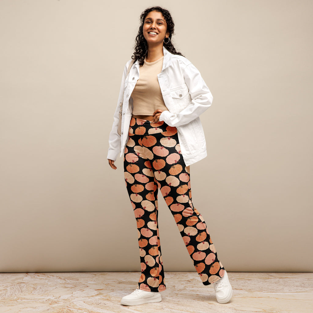 Women’s black high waist flare legging pants with a playful orange and pink pumpkin pattern