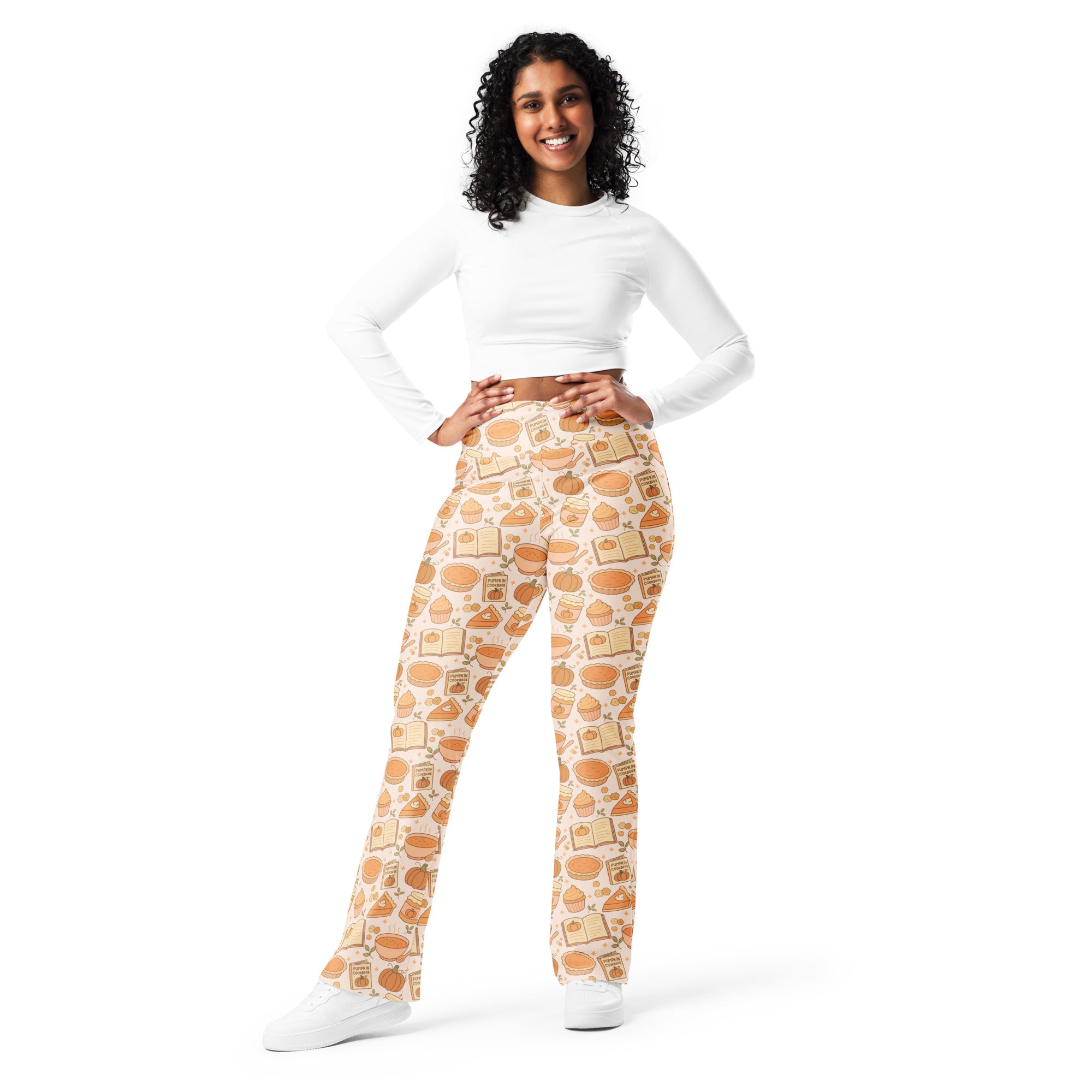 Cream-colored women’s high waist flare leggings with a playful warm brown pumpkin pie themed baked goods and books pattern