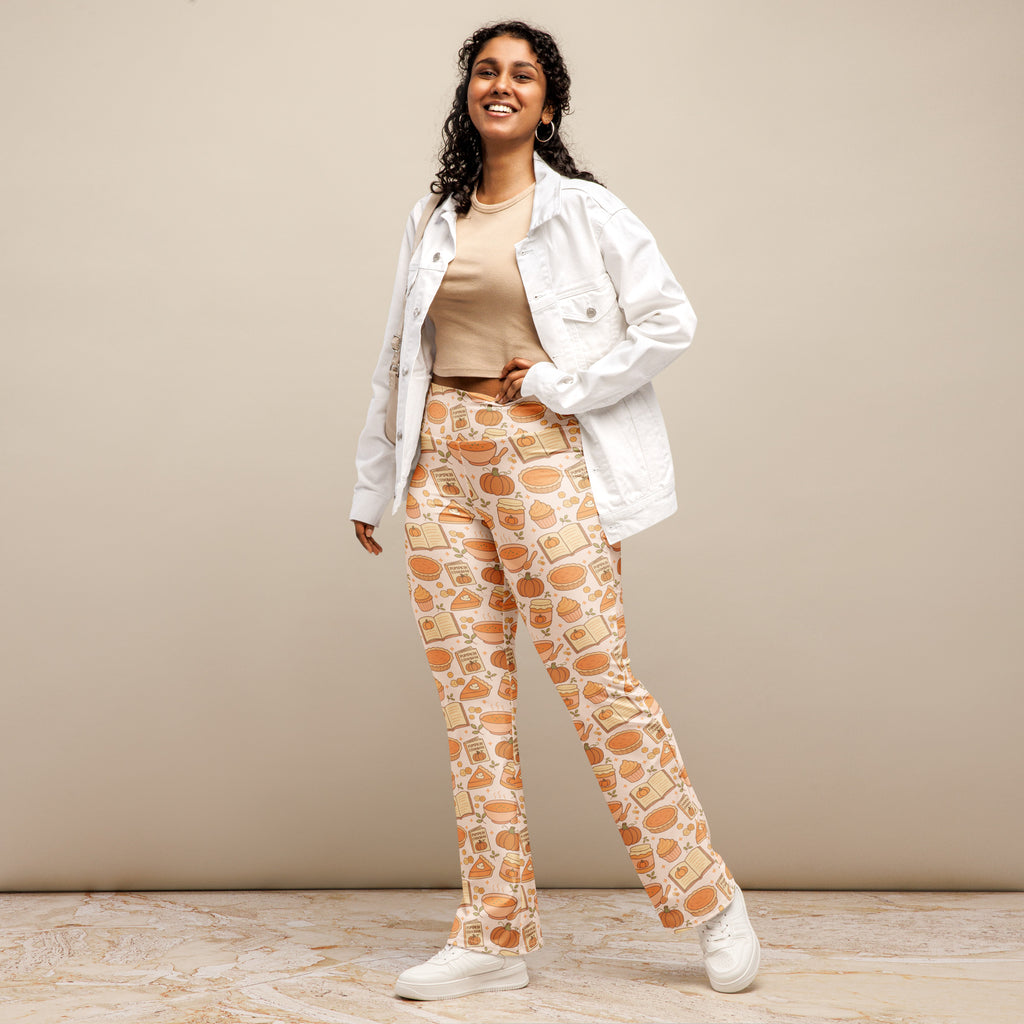 Cream-colored women’s high waist flare legging pants with playful orange pumpkins books and autumn food pattern