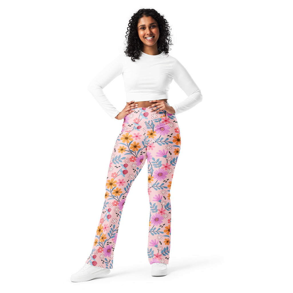 Women’s pink floral high waist flare legging pants with pink orange and purple flowers on a light background