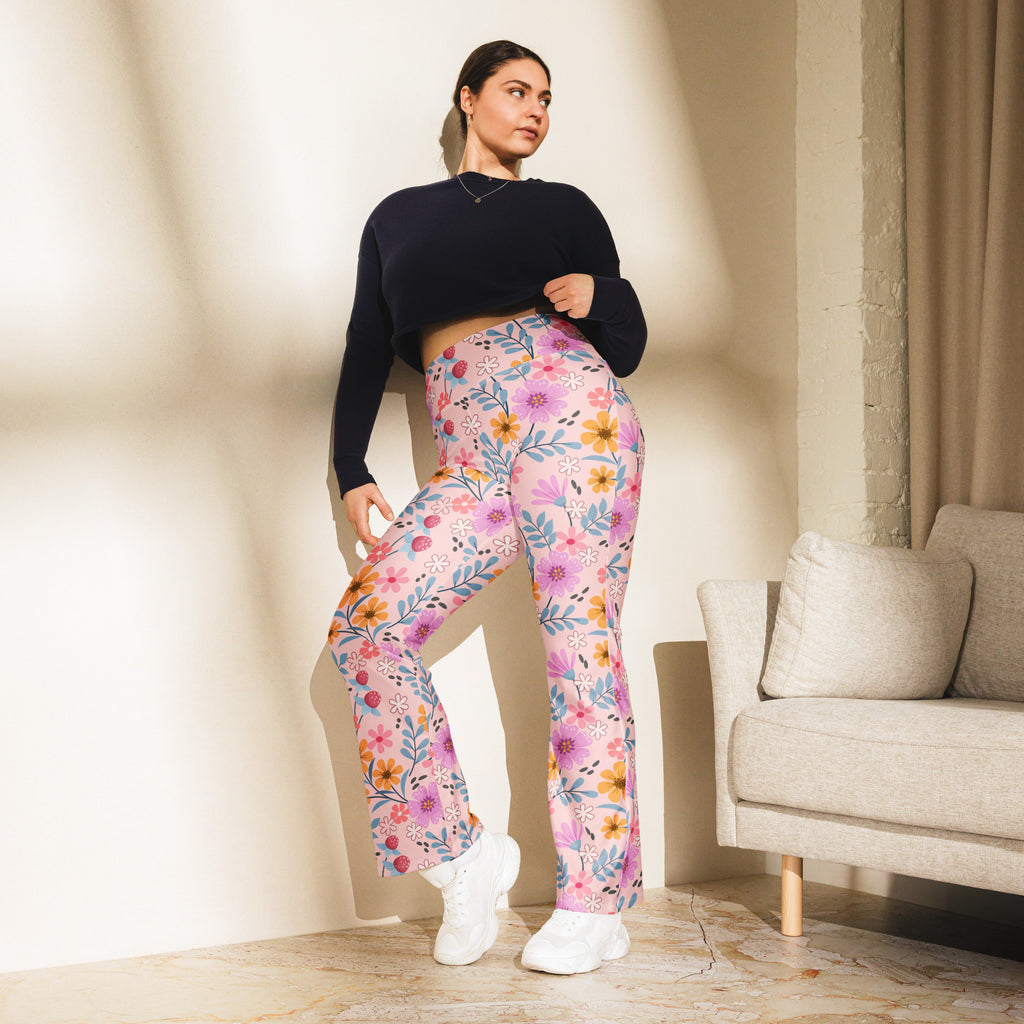 Women’s pink floral high waist flare legging pants with soft flowing fabric and vibrant purple orange blue blossoms