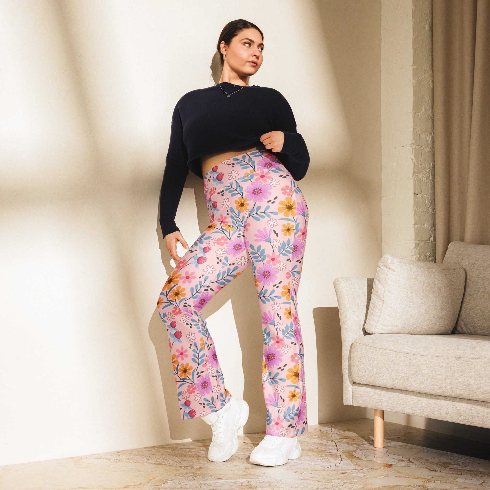 Women’s pink floral high waist flare legging pants with soft flowing fabric and vibrant purple orange blue blossoms
