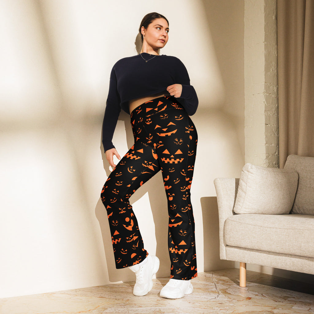 Women’s black halloween-themed high waist flare leggings with orange jack-o-lantern faces and triangular patterns