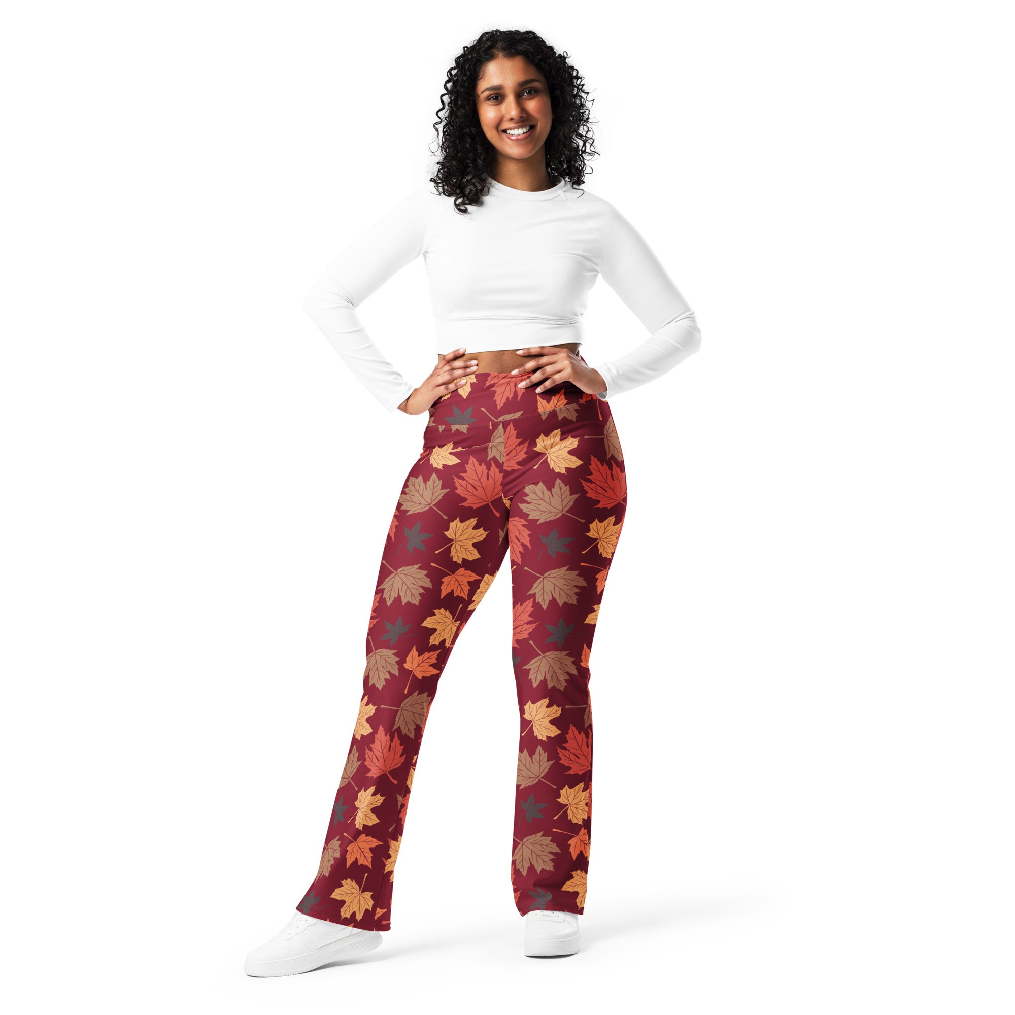 Women’s maroon high waist flare leggings with vibrant orange brown and gold autumn leaf pattern