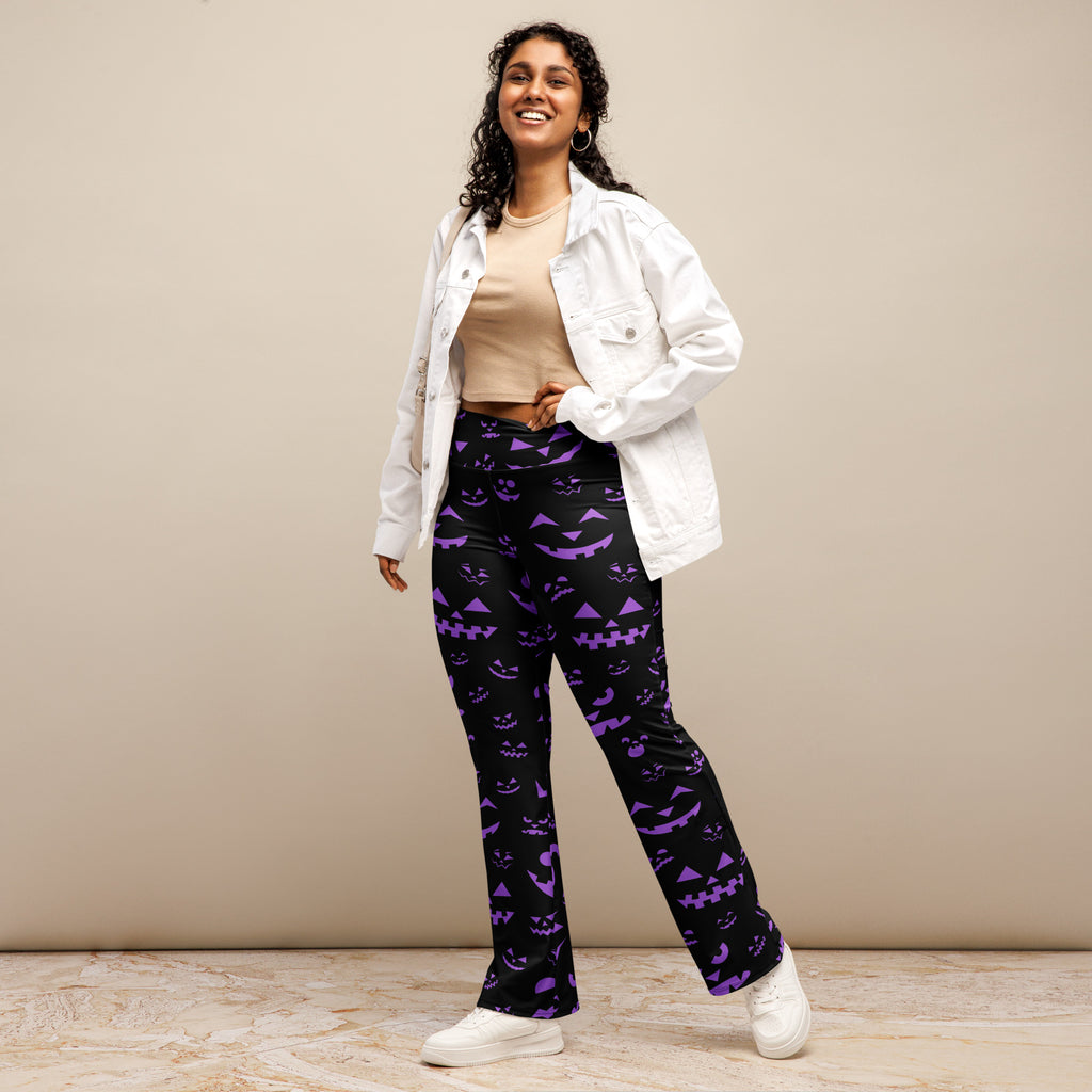 Women’s black high waist flare pants with vibrant purple jack-o-lantern halloween pattern