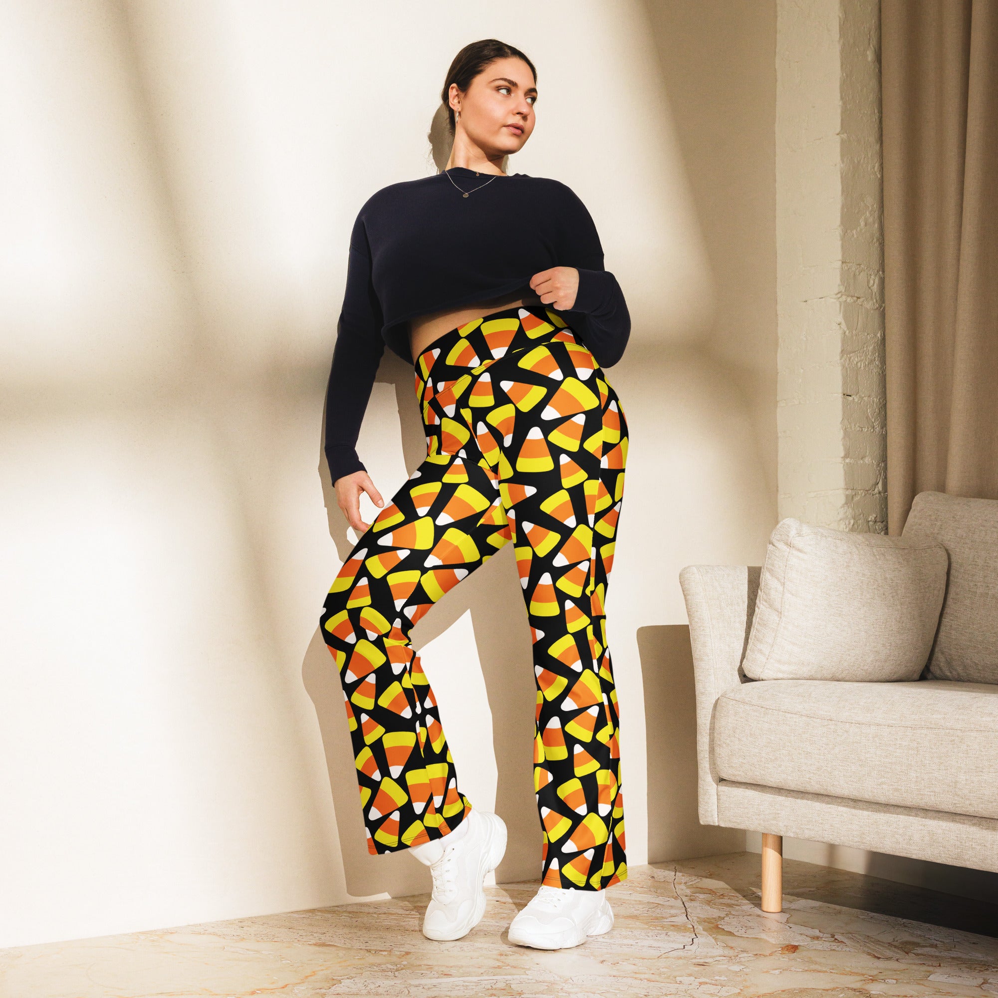 Women’s candy corn high waist flare legging pants in black and yellow candy corn pattern with flared legs
