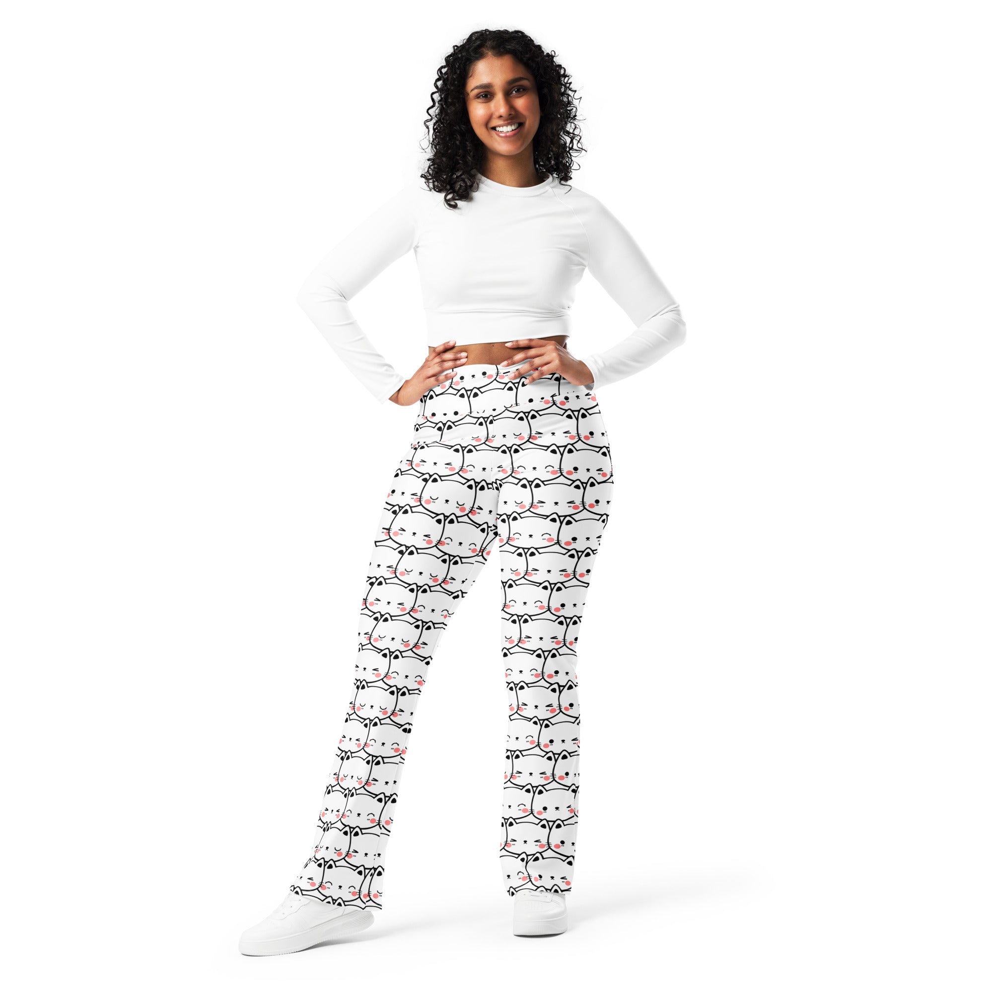 Women’s white high waist flare legging pants with playful black outlined cartoon cats and pink accents pattern