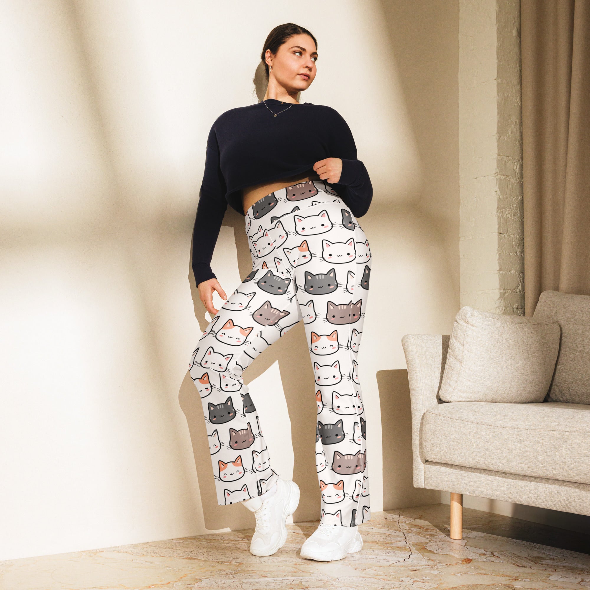 White plus size high waist flare legging pants with a cute playful pattern of gray black and orange cartoon cats
