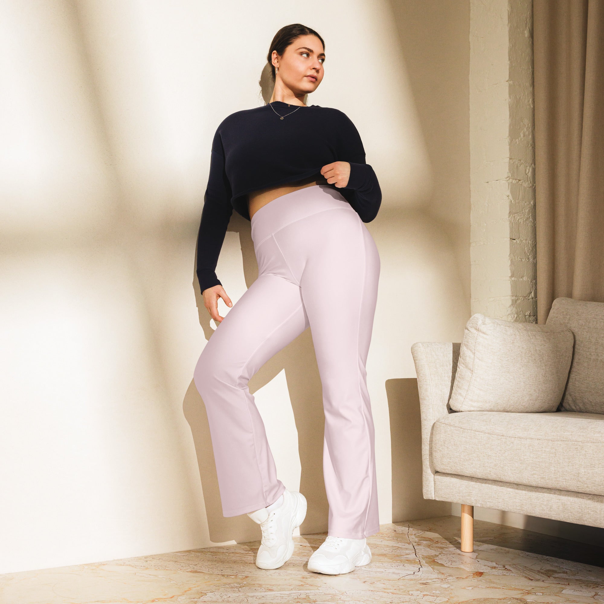 Women’s light pink high waist flare leggings made of soft lavender fabric shown from the back side