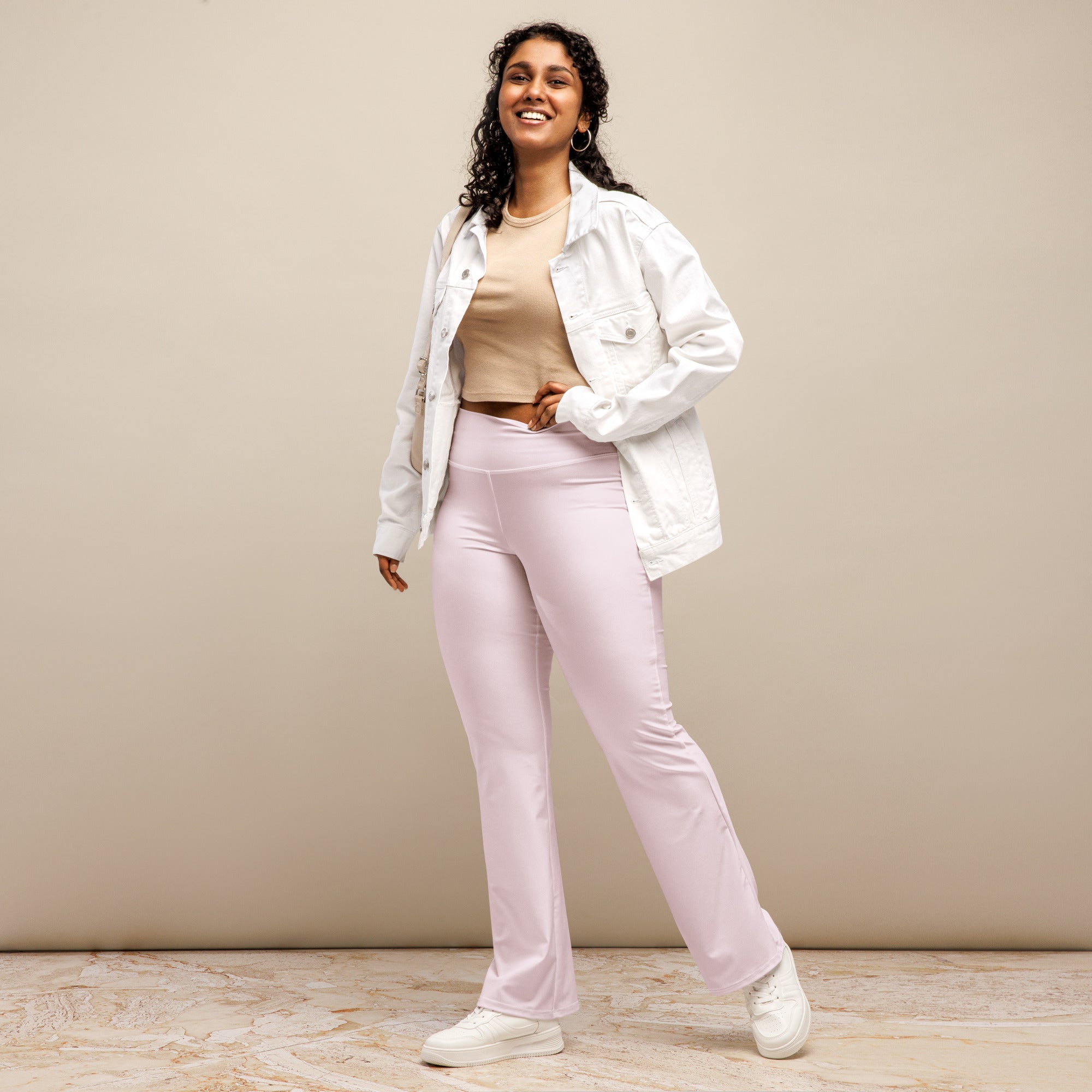 Women’s light pink high waist flare legging pants made of soft stretchy fabric for casual and stylish wear
