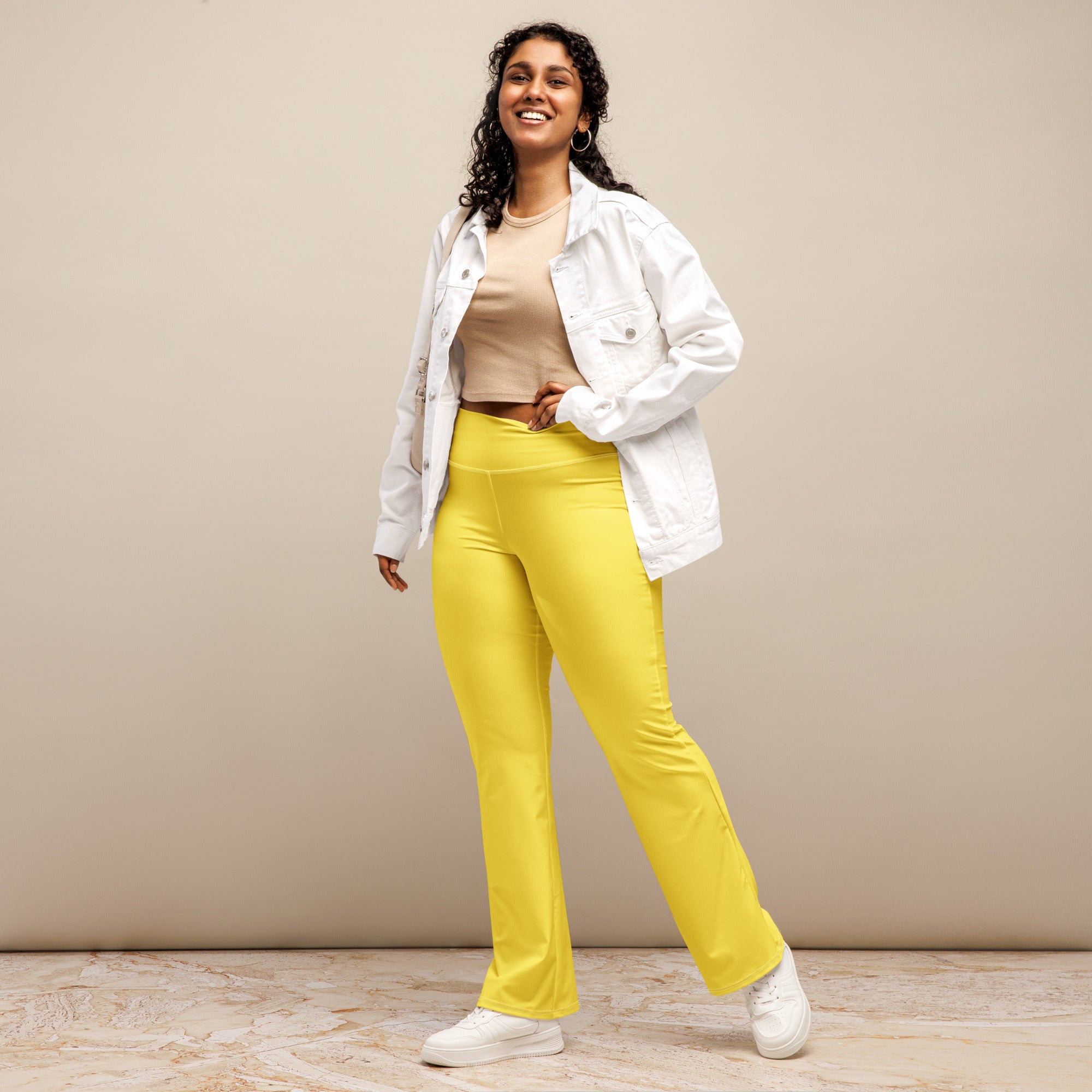 Women’s yellow high waist flare legging pants made of smooth stretchy fabric with bright yellow color