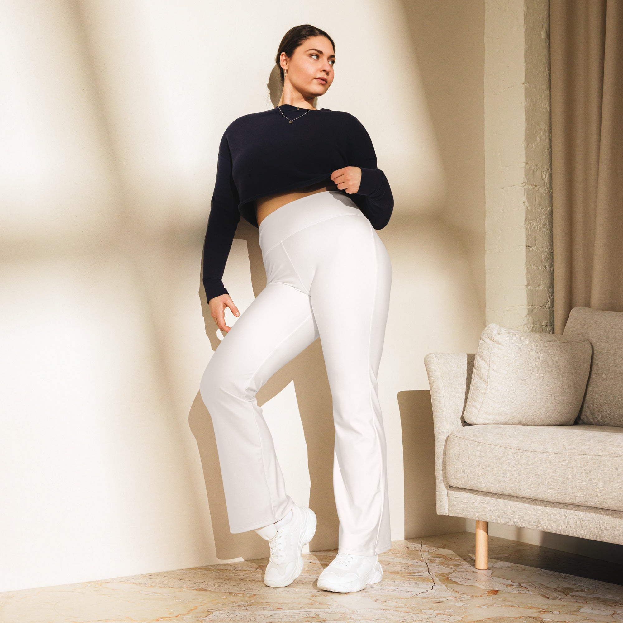 Women’s white high waist flare legging pants made of stretchy fabric for a flattering and comfortable fit