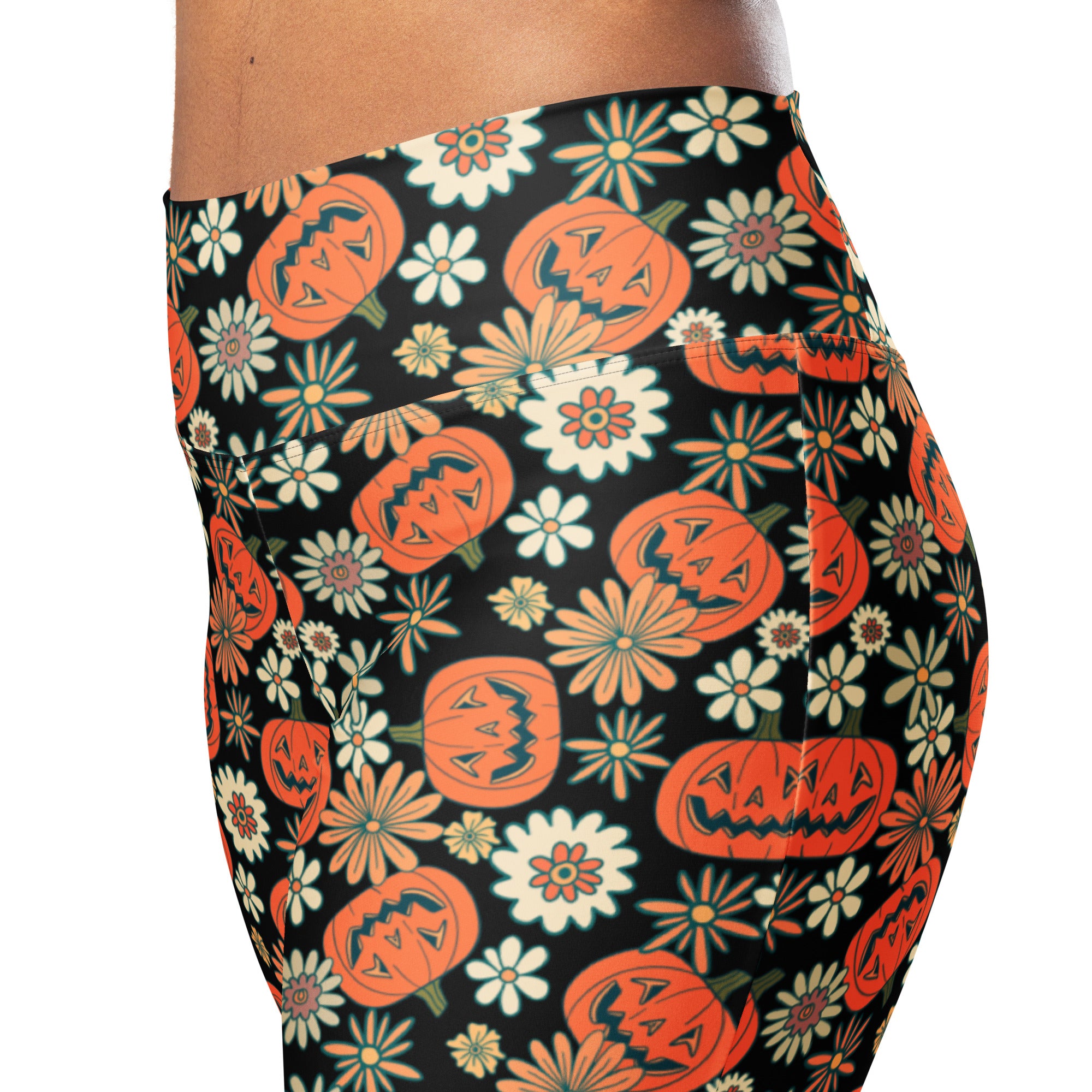 Black high waist flare leggings with vibrant orange jack o lantern and multicolored floral pattern for women