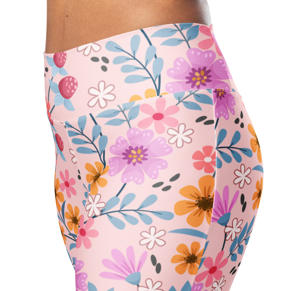 Women’s pink floral high waist flare leggings with vibrant purple orange and white flowers on light pink background