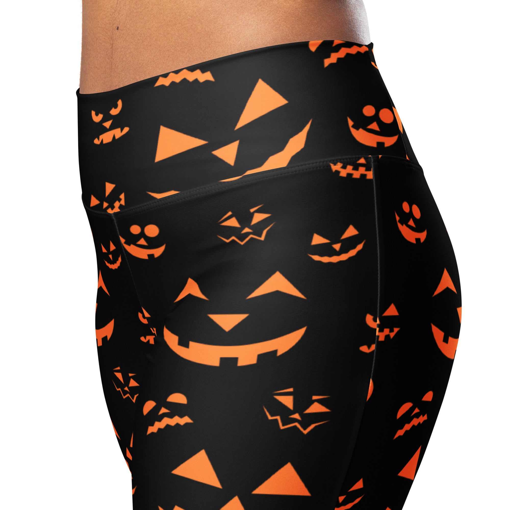 Women’s black high waist flare leggings with vibrant orange jack-o-lantern face pattern for Halloween wear