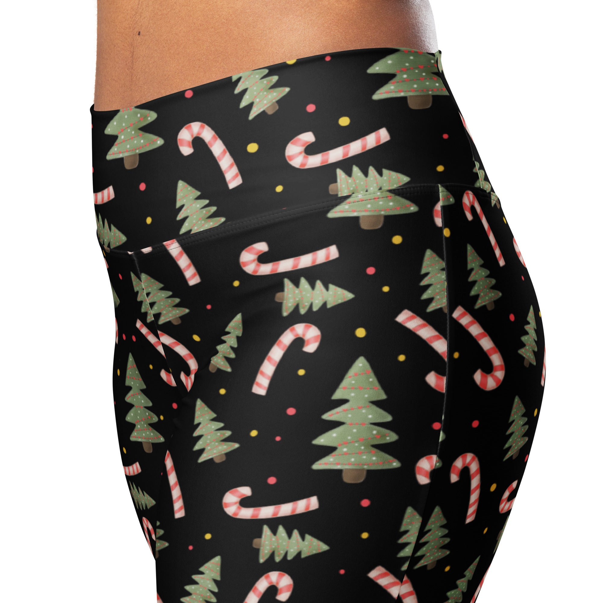 Black high-waisted womens leggings with festive green christmas trees and red and white candy cane pattern