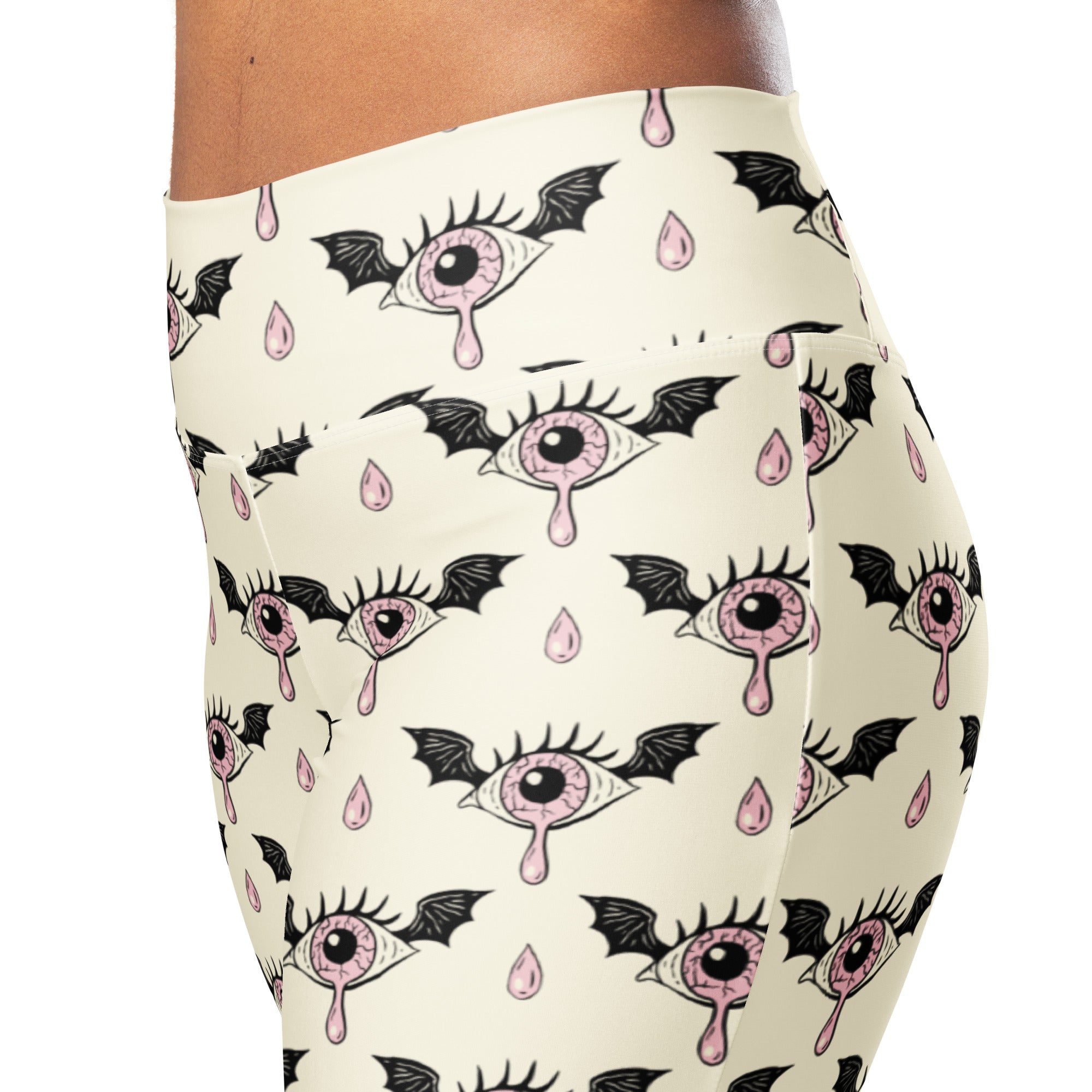 Cream-colored womens gothic eyeball bat high waist flare leggings with stylized eyes black wings and pink teardrops