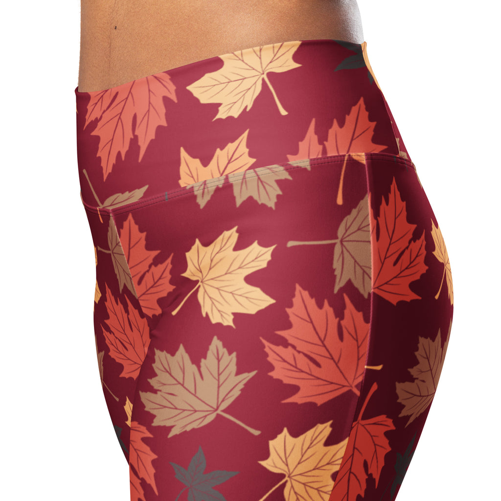Women’s maroon high waist flare leggings with vibrant orange yellow beige autumn leaf pattern for fall wear