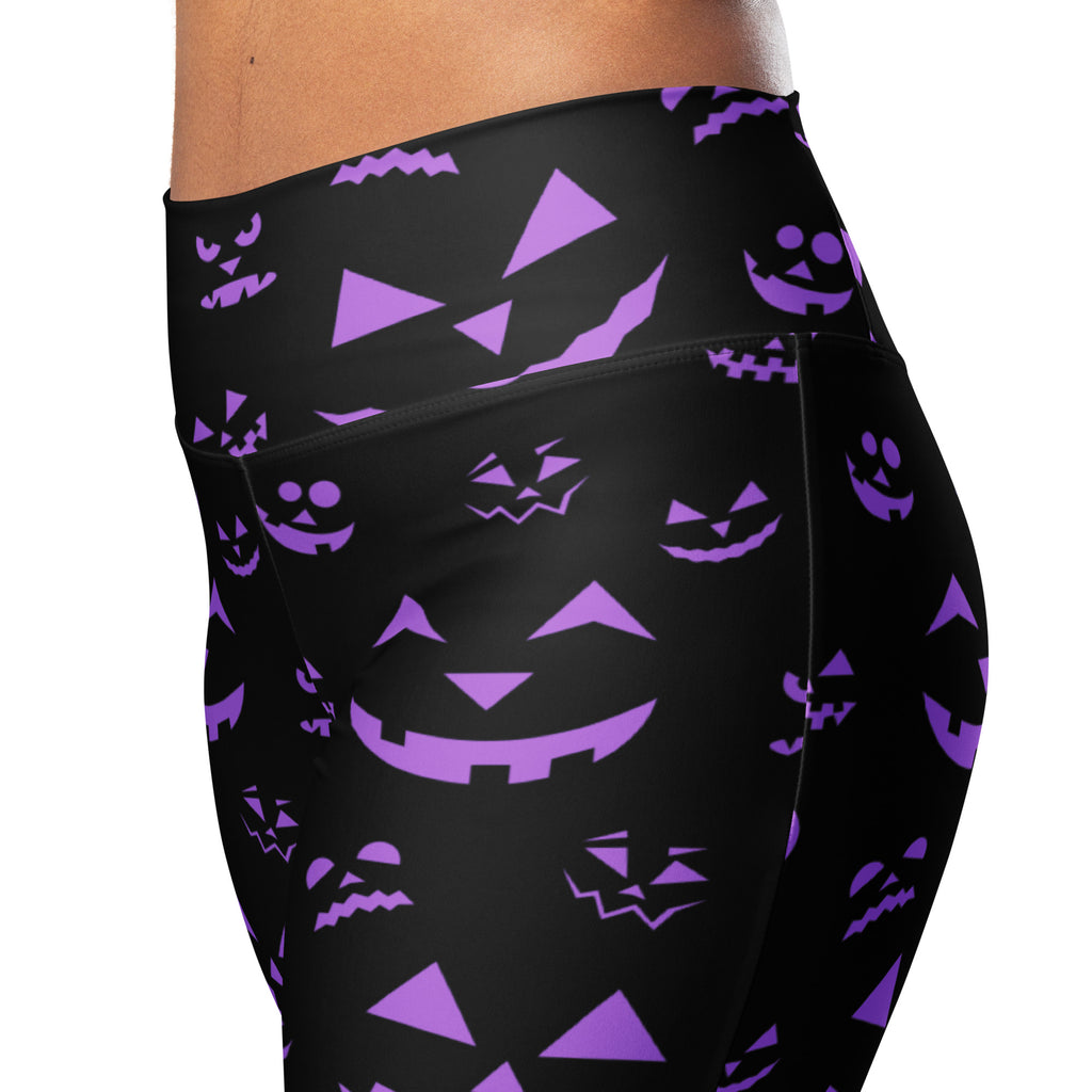 Black high-waisted women’s leggings with vibrant purple jack-o-lantern face pattern perfect for Halloween wear