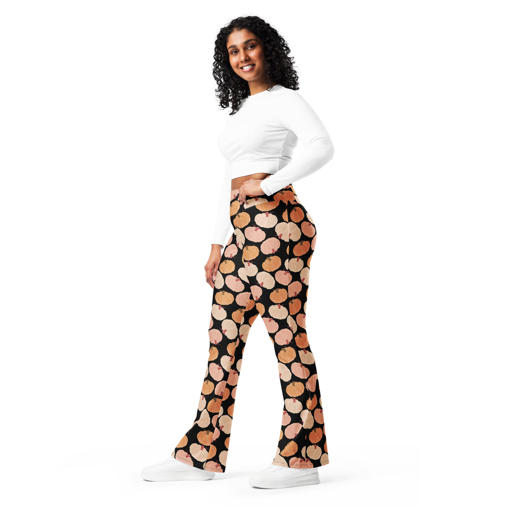 Women’s black high waist flare legging pants with a playful peach and orange pumpkin pattern for fall wear
