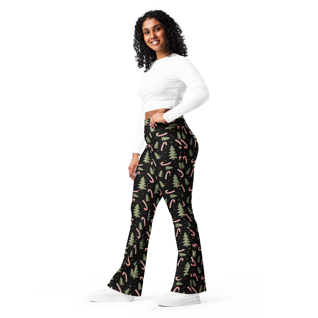 Women’s black high waist flare legging pants with pink candy cane and green pine tree festive pattern
