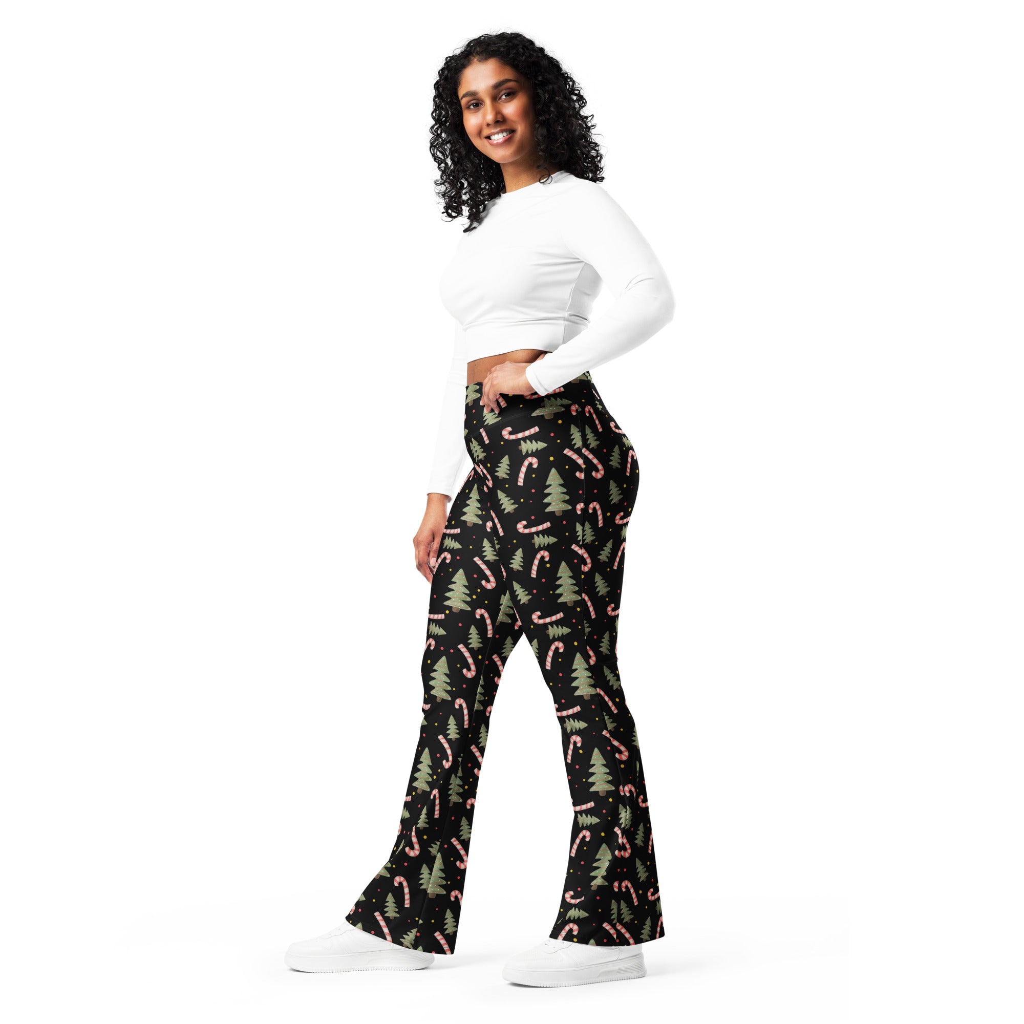 Women’s black high waist flare legging pants with pink candy cane and green pine tree festive pattern