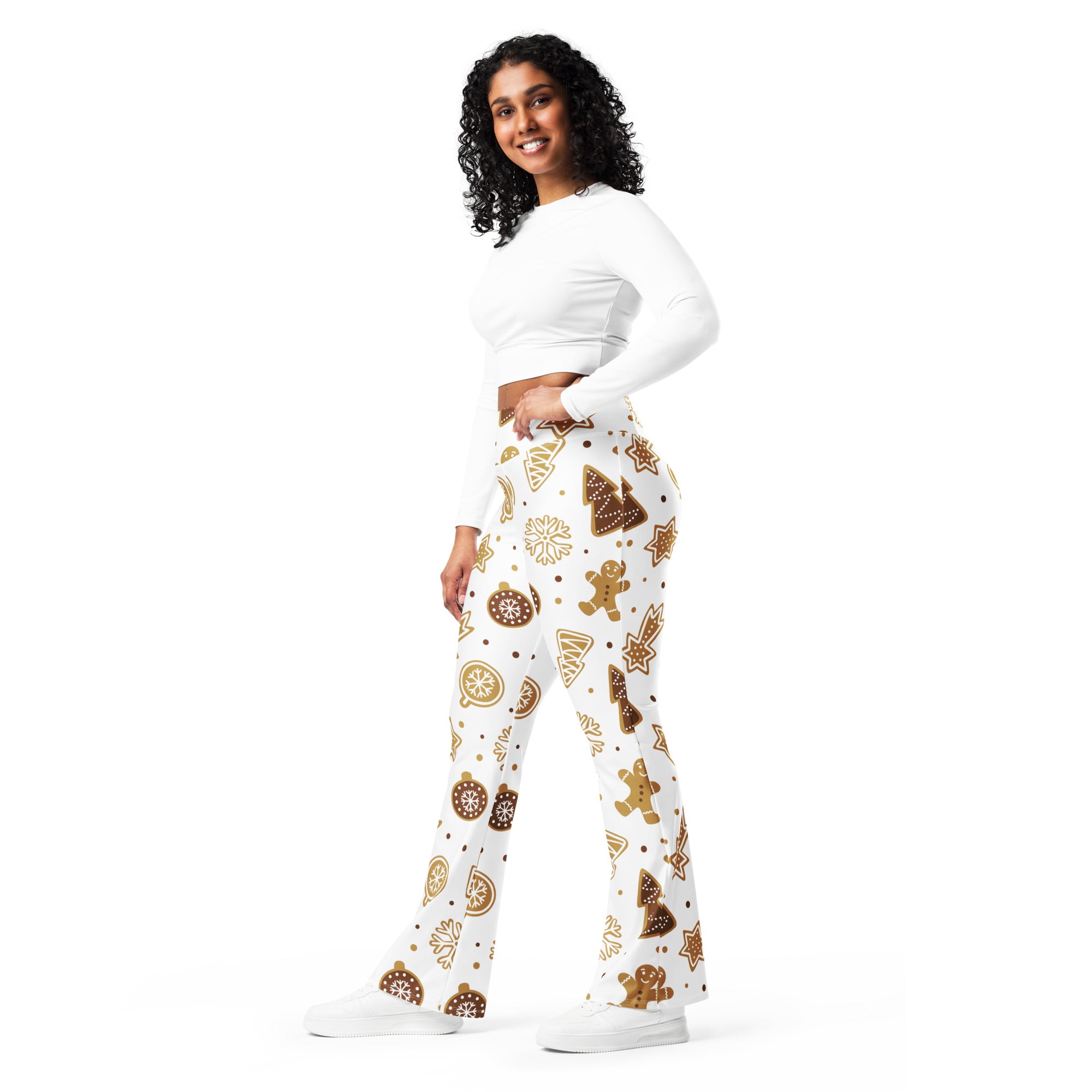 White flared pants with festive brown gingerbread cookies christmas trees ornaments and snowflakes pattern for women