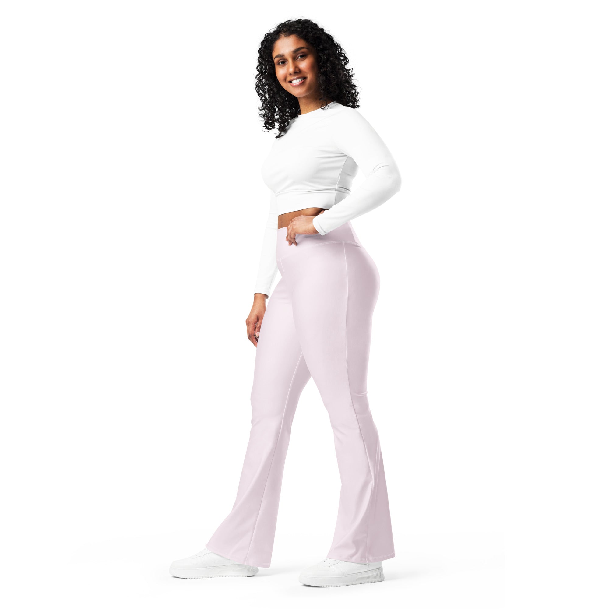 A pair of women’s light pink high waist flare leggings made of smooth stretchy fabric for comfortable wear