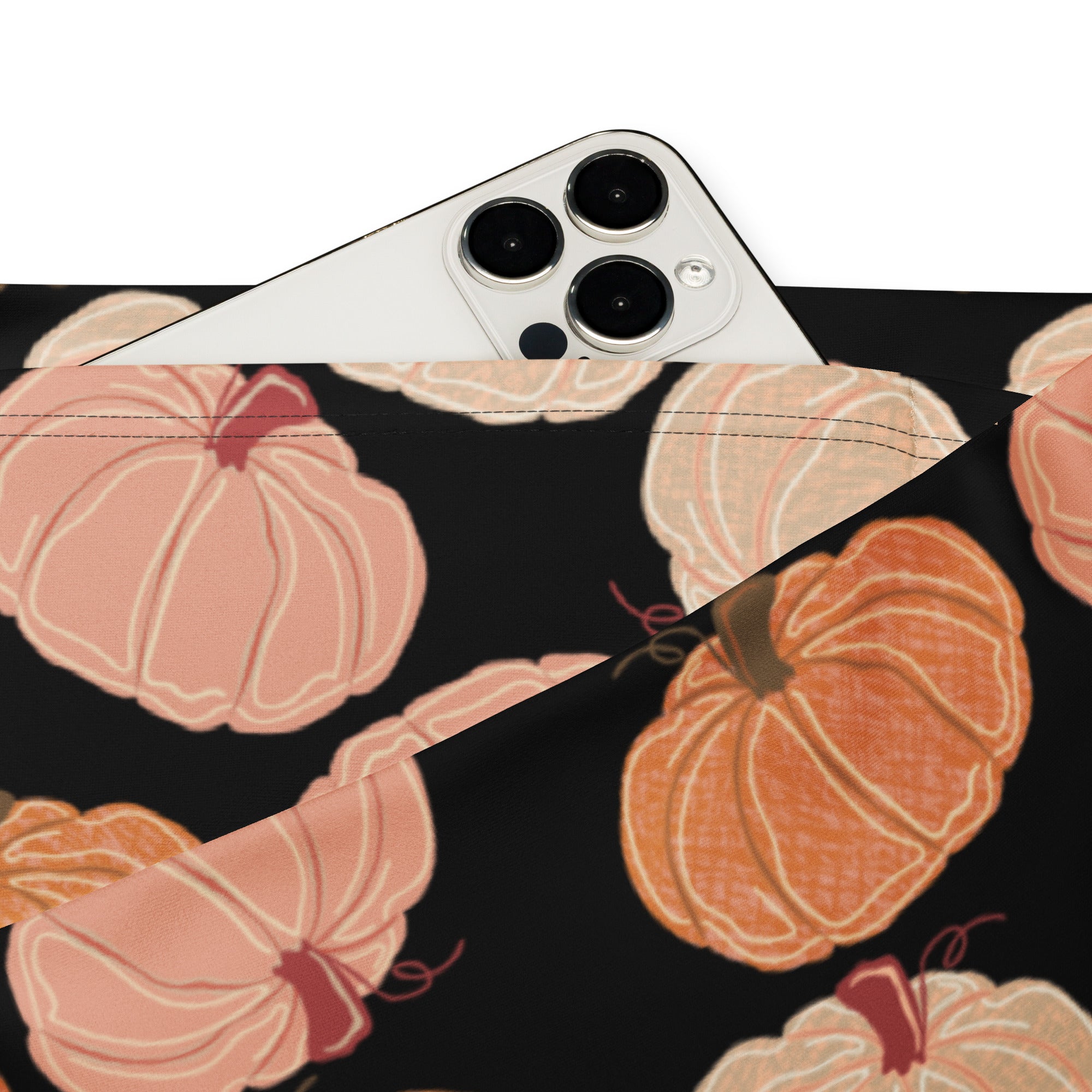 Black fabric pouch with playful orange and pink pumpkin pattern paired with women’s pumpkin patch high waist flare leggings