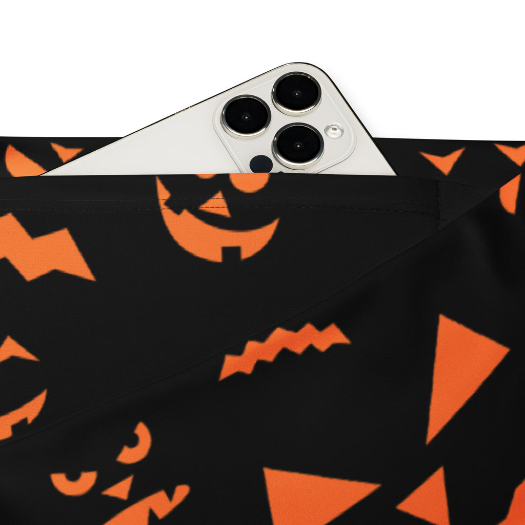 Black fabric pouch with orange halloween jack o lantern faces and geometric shapes matching women’s leggings design