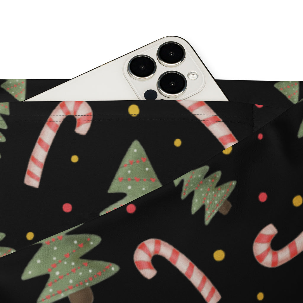 Black fabric pouch with festive red and green candy cane and christmas tree patterns for holiday use