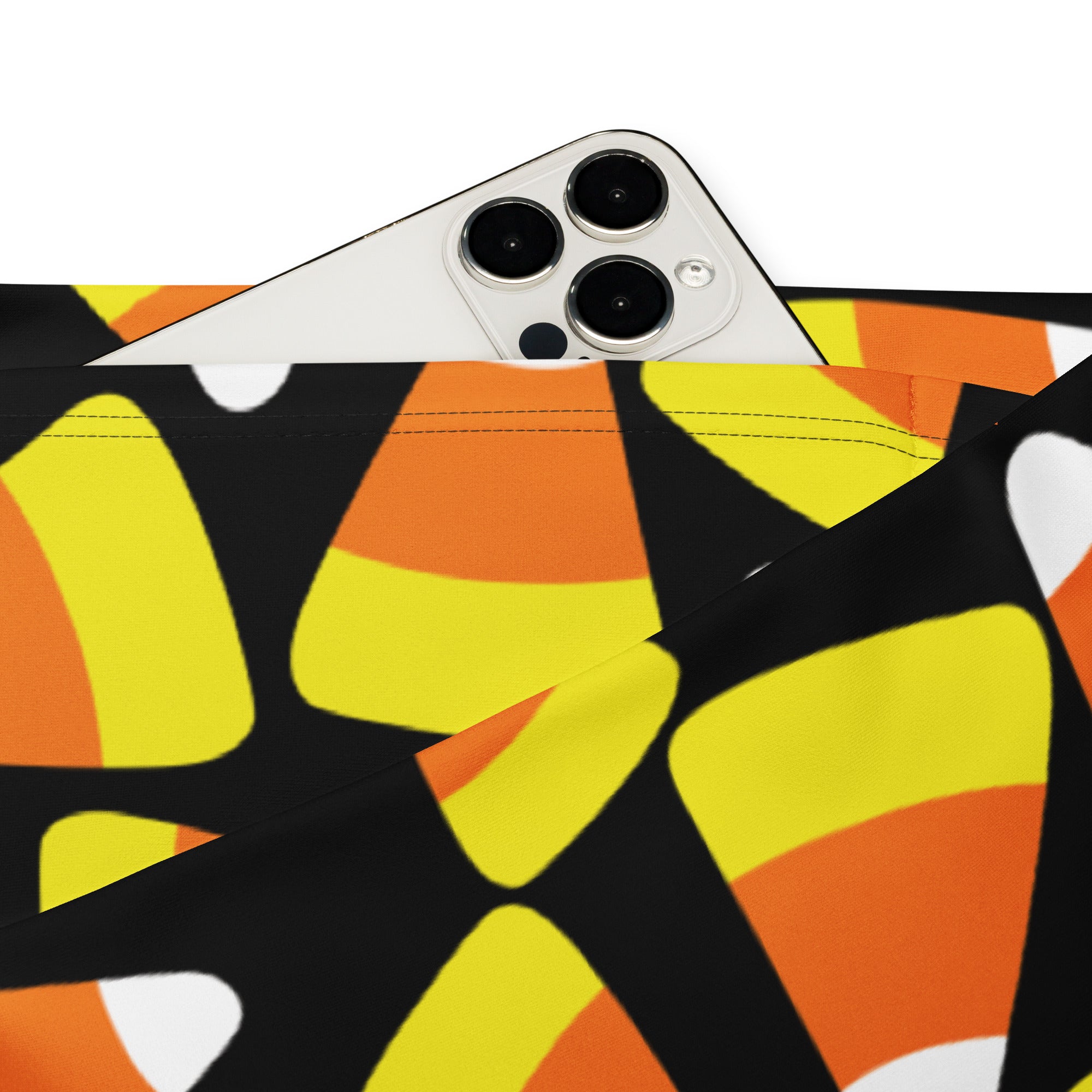 A black fabric pouch with a bold stylized candy corn pattern in bright orange and yellow