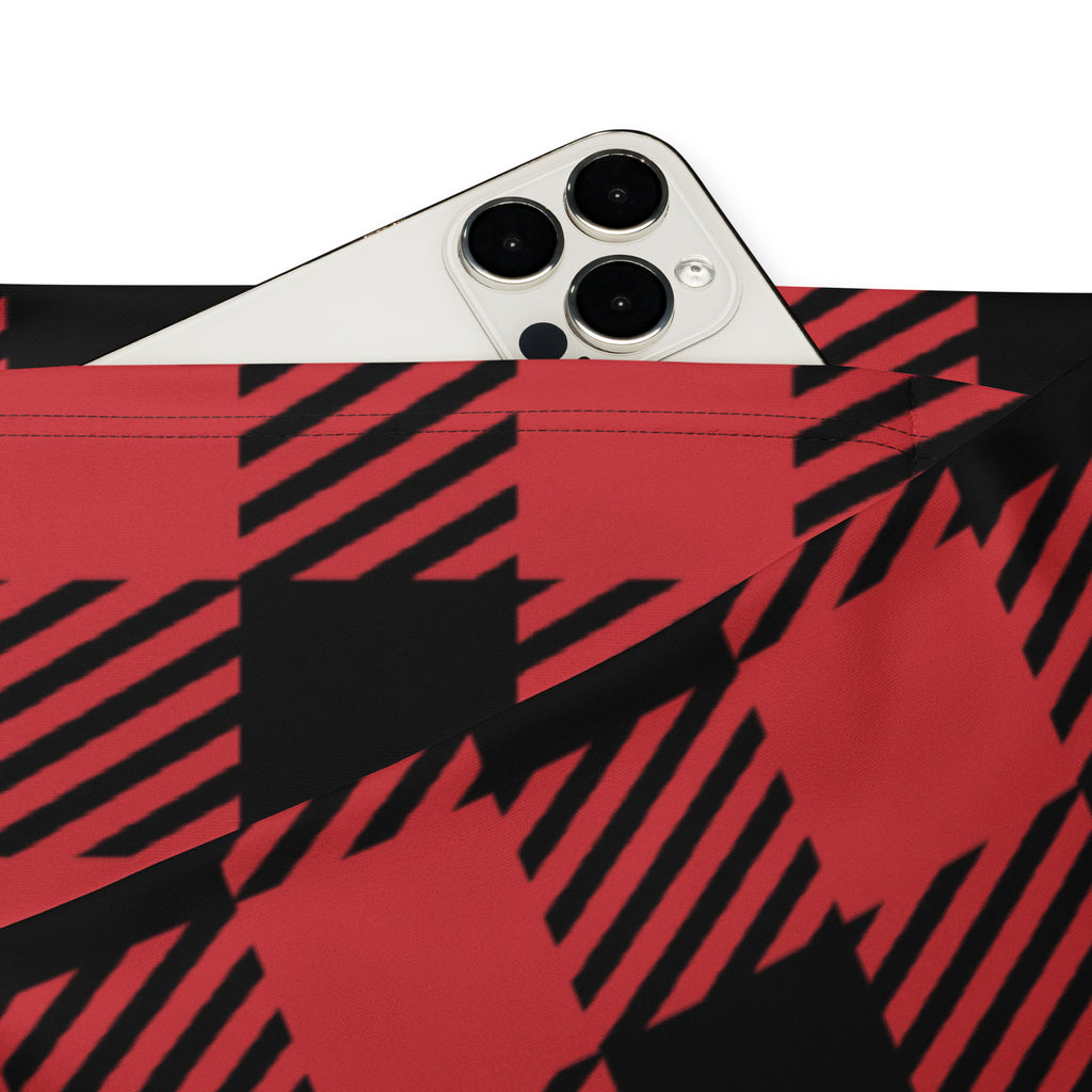 Women’s red buffalo plaid high waist flare legging pants shown with a red and black plaid fabric pouch holding a white smartphone