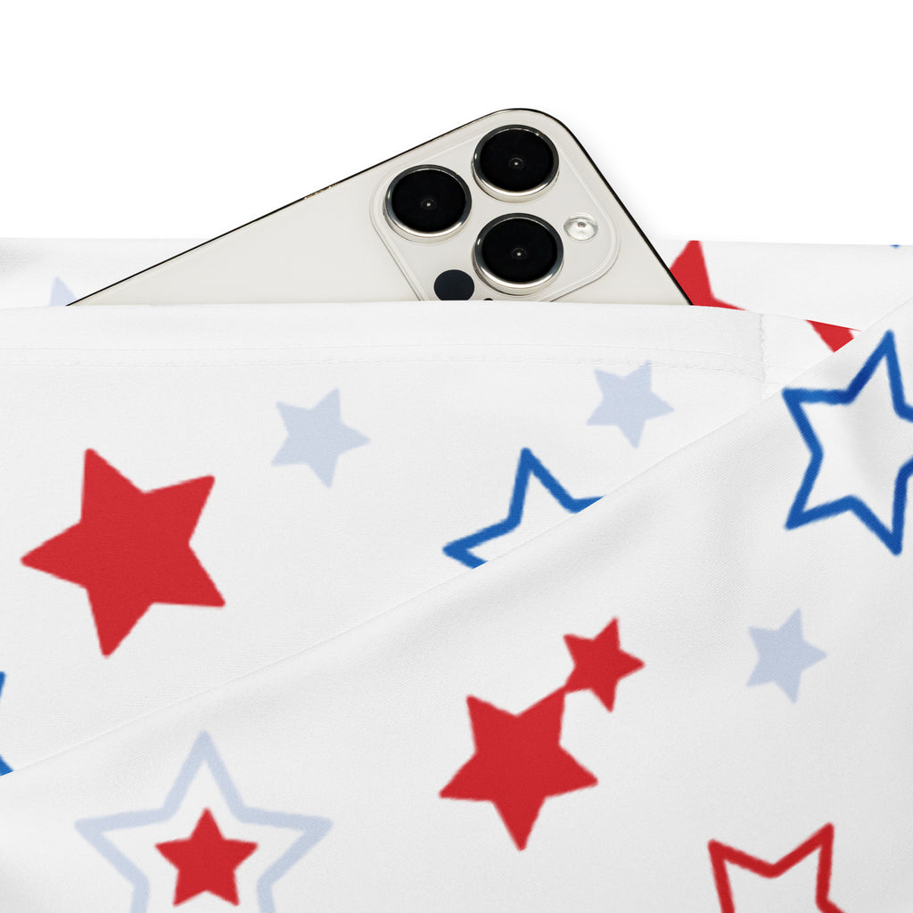 White fabric pouch with red and blue star patterns holding a silver iphone for women’s red white and blue stars high waist flare legging pants