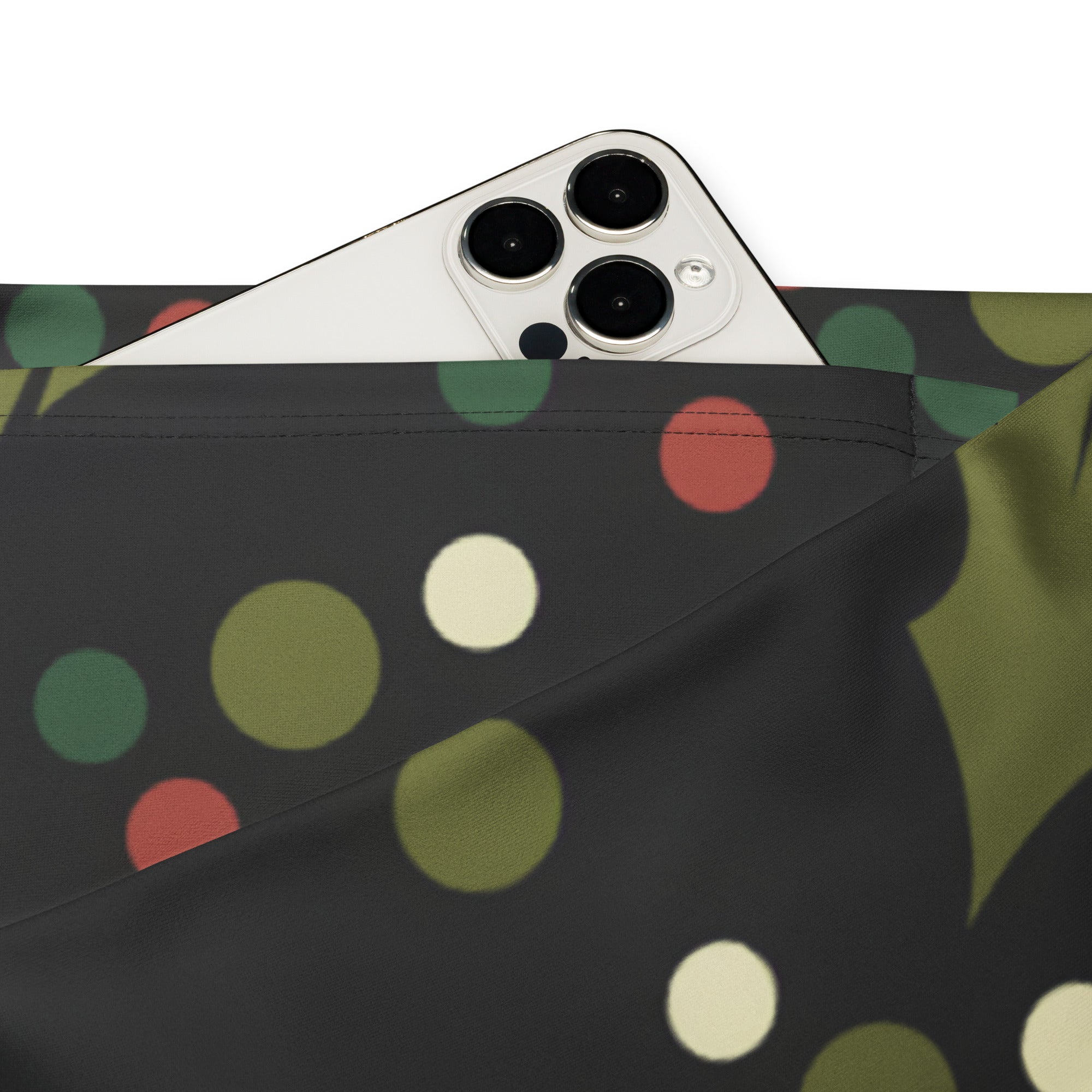 A black fabric pouch with playful green red and cream polka dots for women’s holly print christmas high waist flare legging pants
