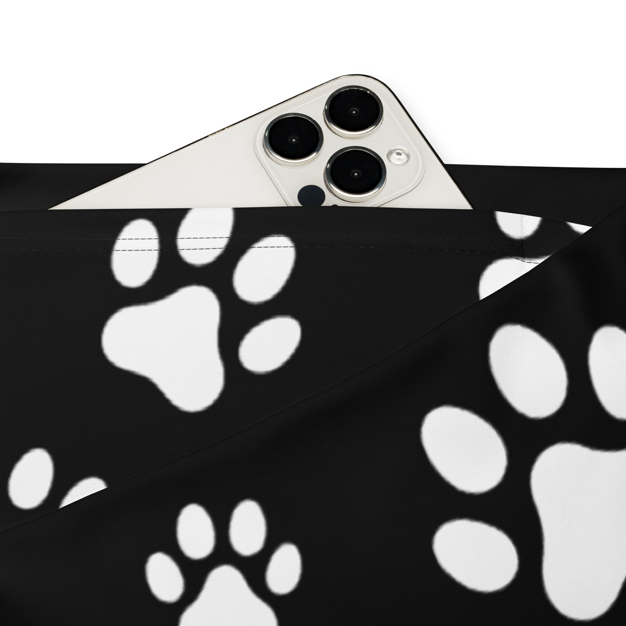 Black paw print fabric pouch partially concealing a silver smartphone with women’s black paw print high waist flare legging pants