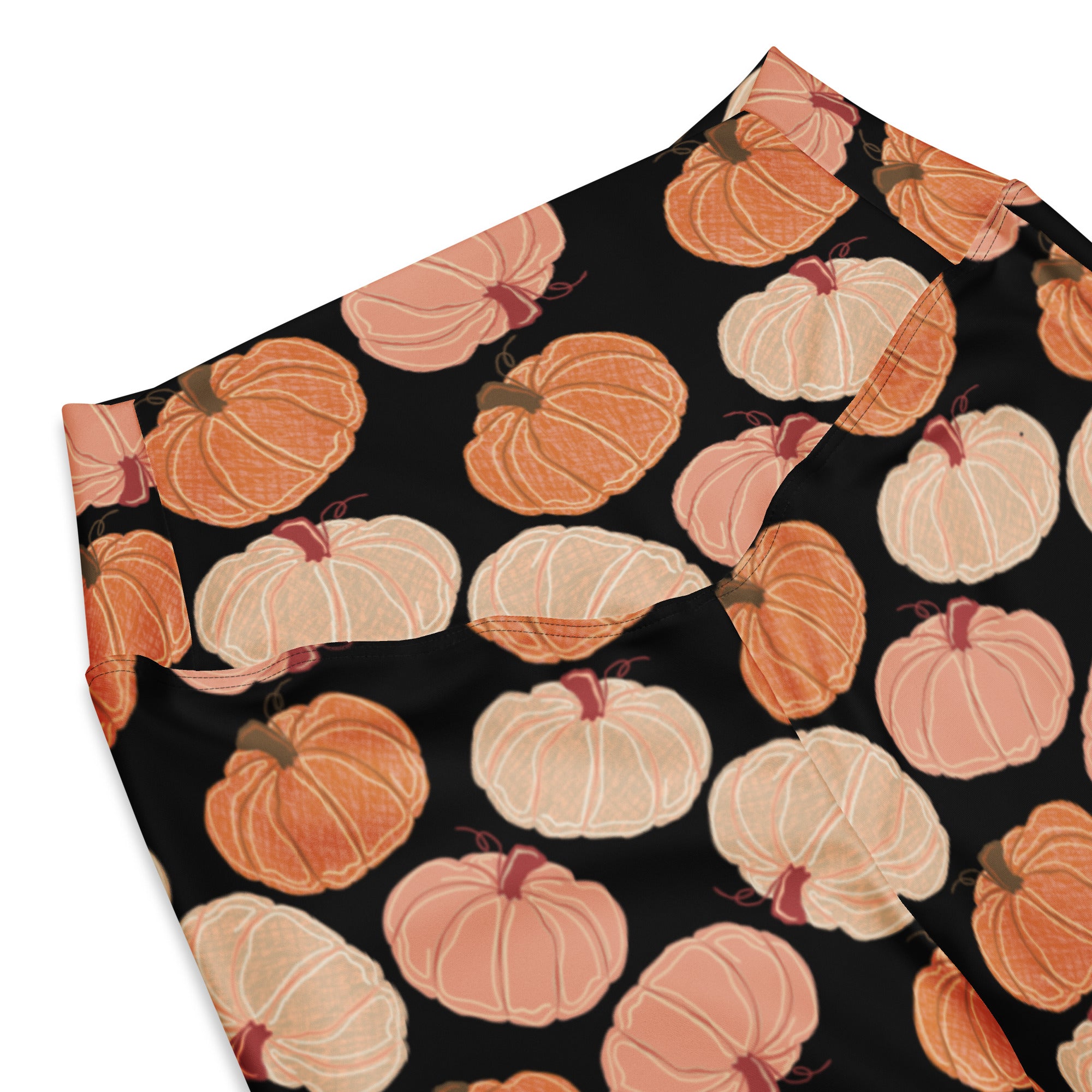 Women’s pumpkin patch high waist flare legging pants in black fabric with repeating orange and peach pumpkin pattern